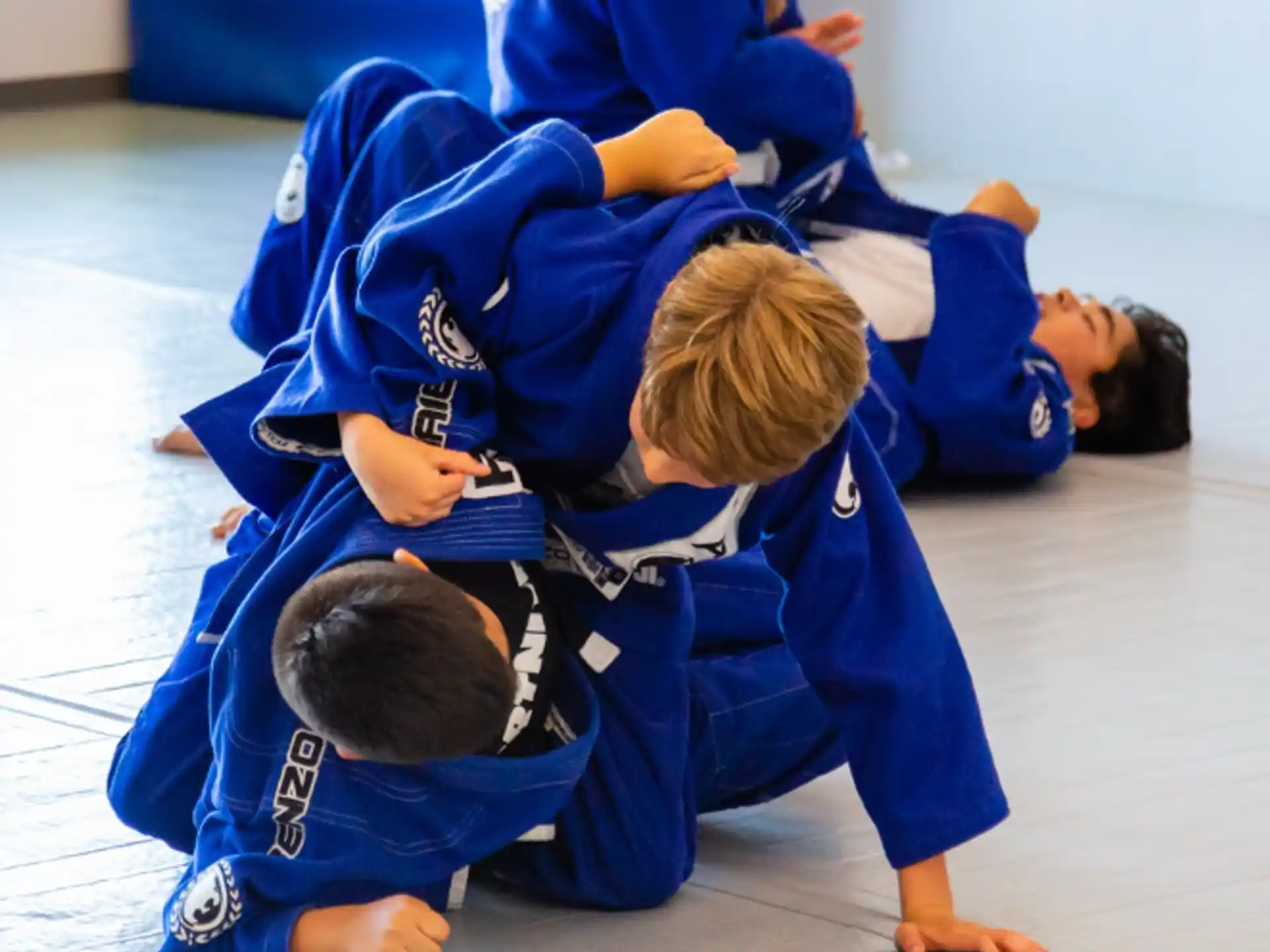 a group of kids in blue karate uniforms