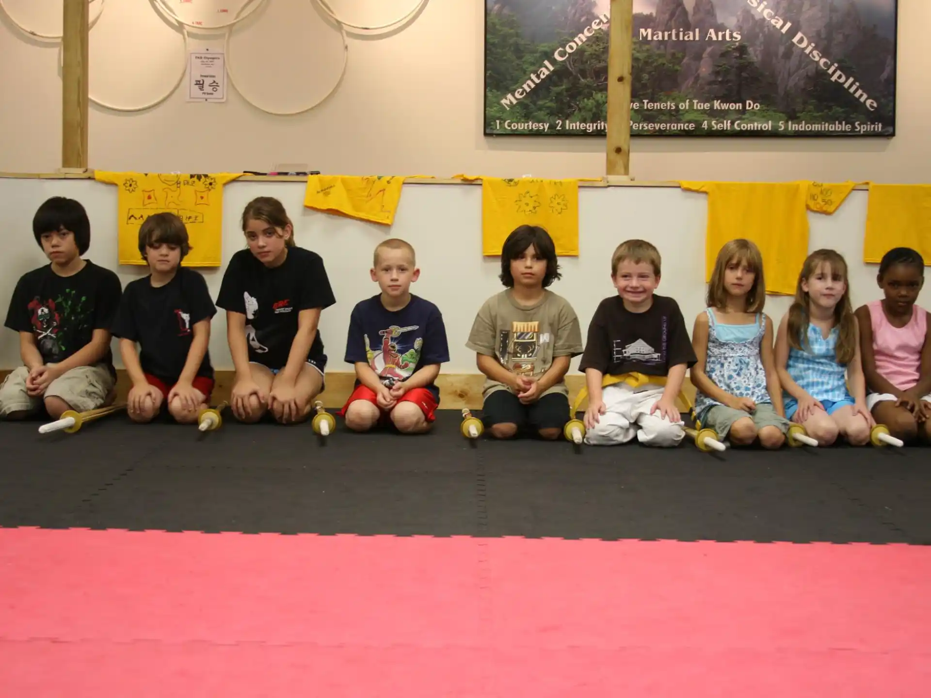 a group of people sitting on the floor posing for the camera