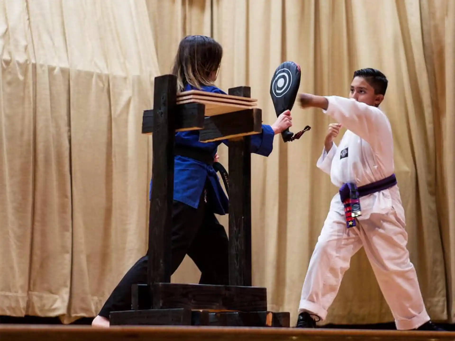 a man and a woman on a stage with a shield and sword