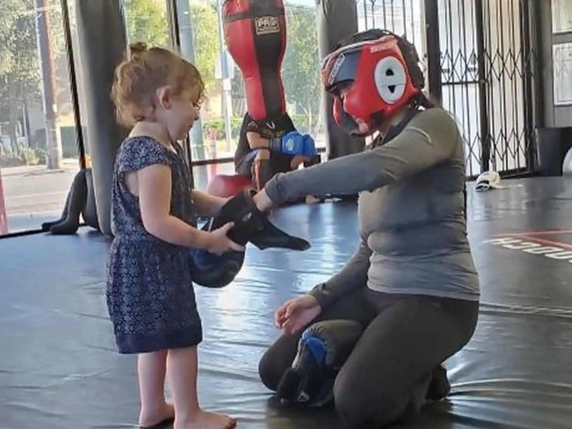 a child standing next to a person in a garment
