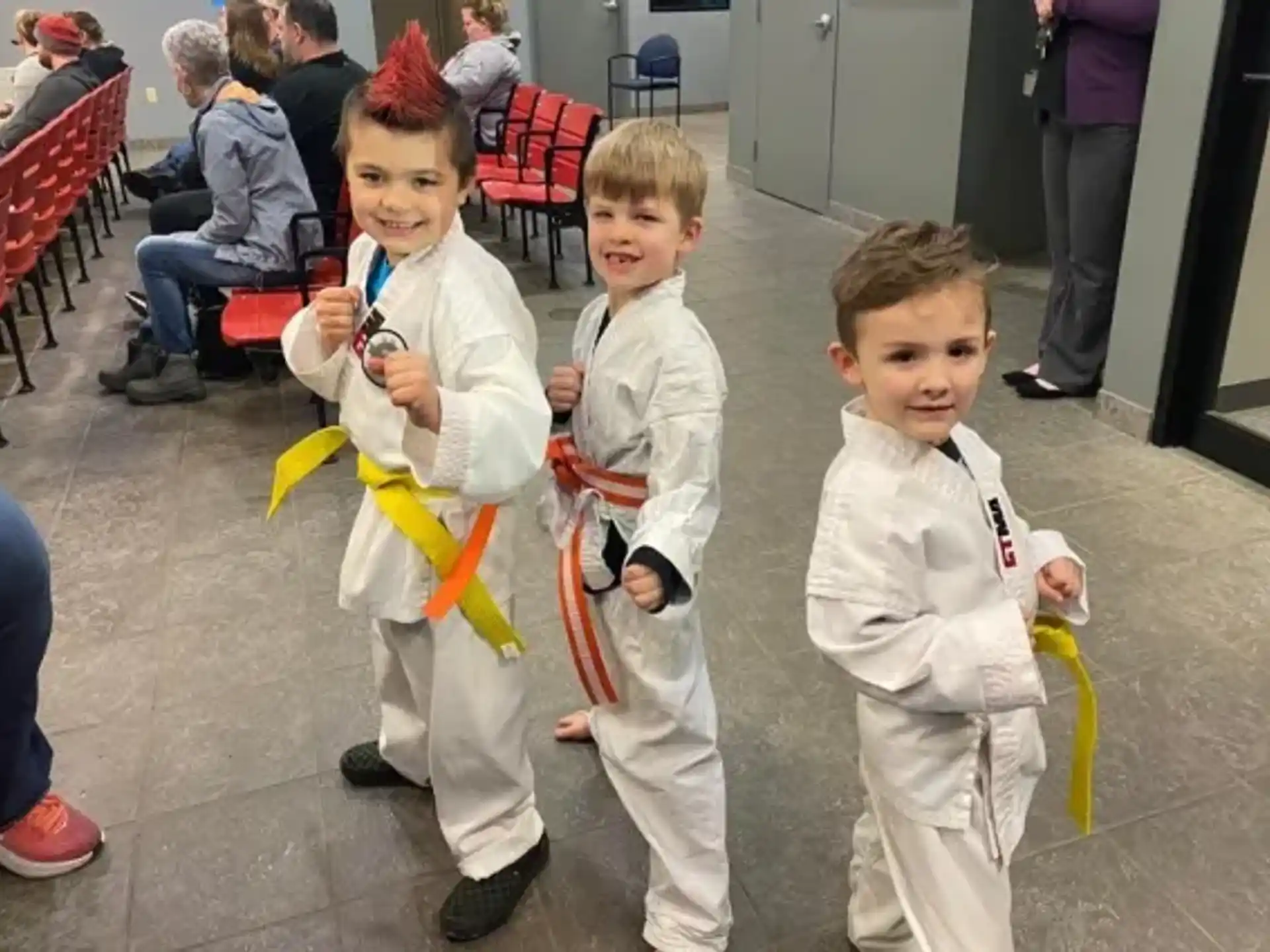 a group of children in white karate uniforms