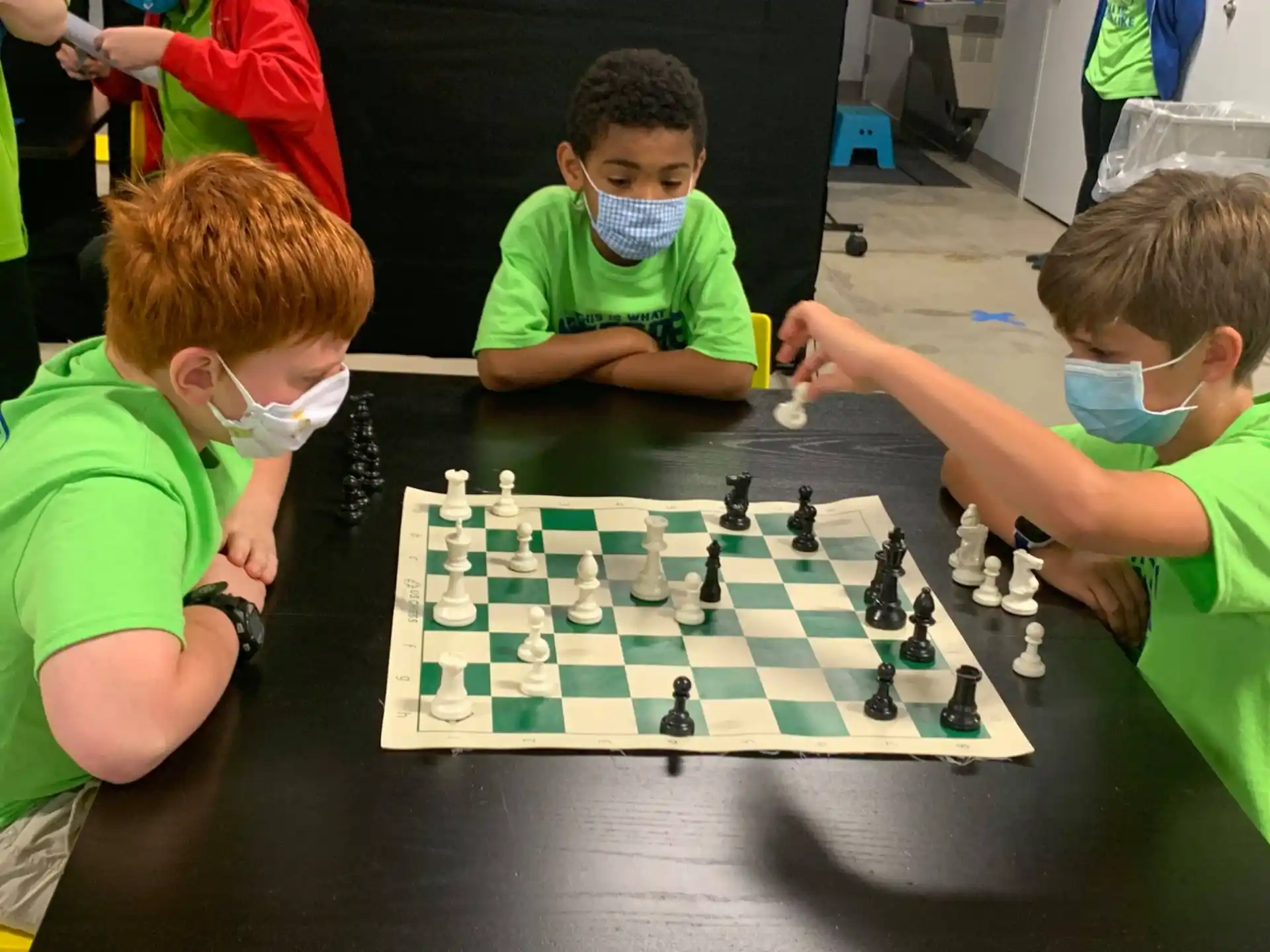 a group of boys playing chess