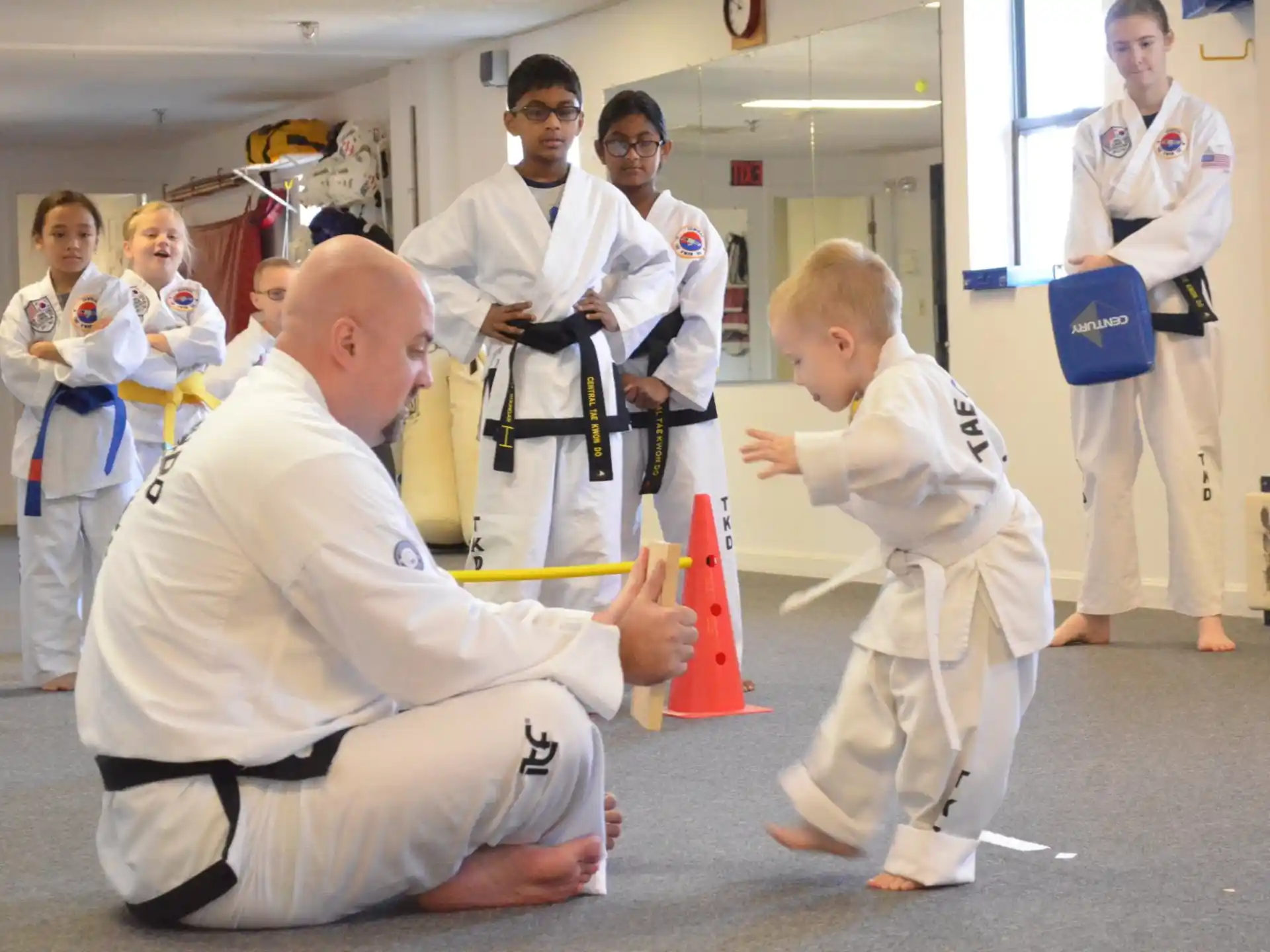 a group of people in white karate uniforms