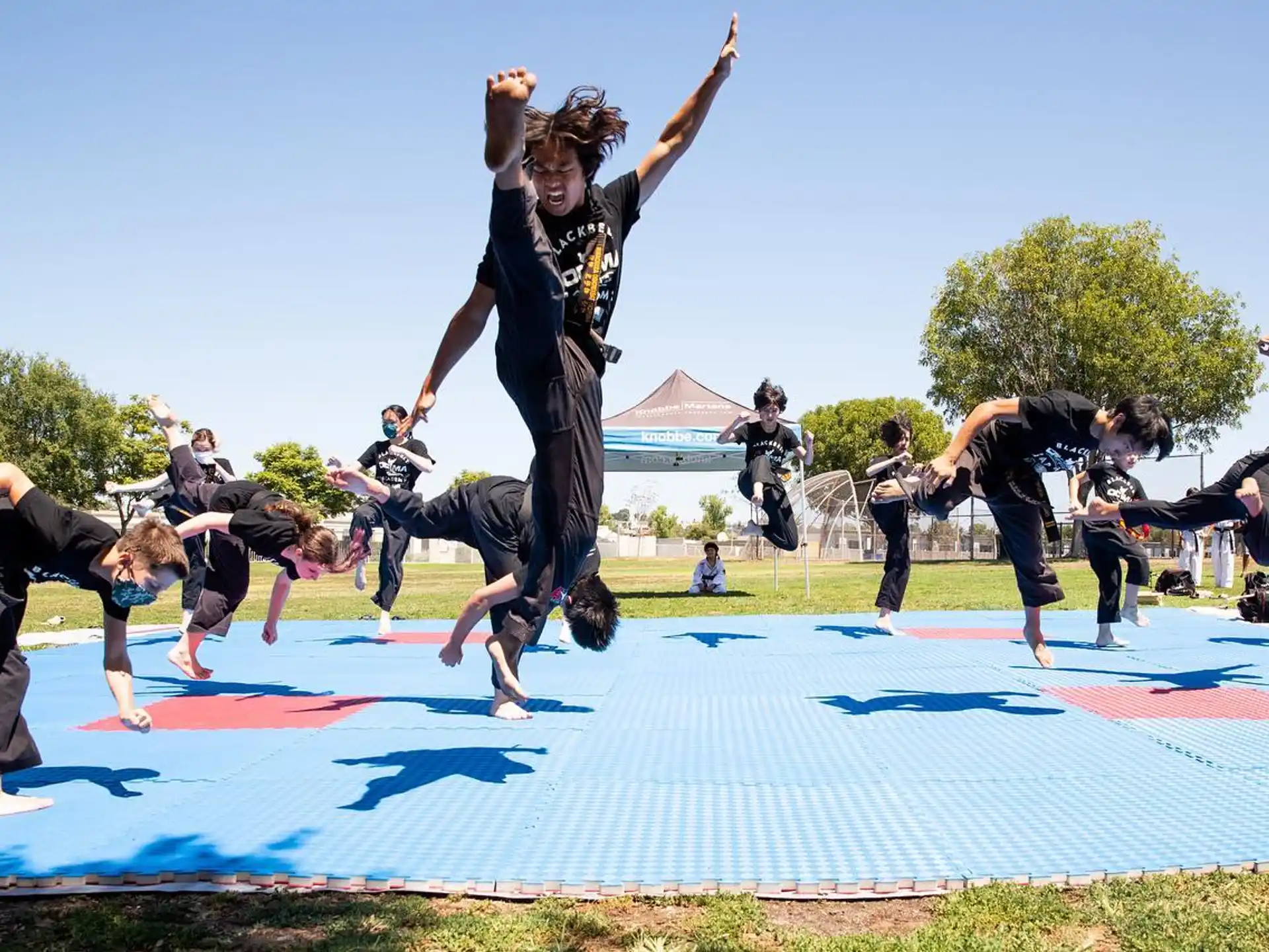 a group of people jumping on a trampoline