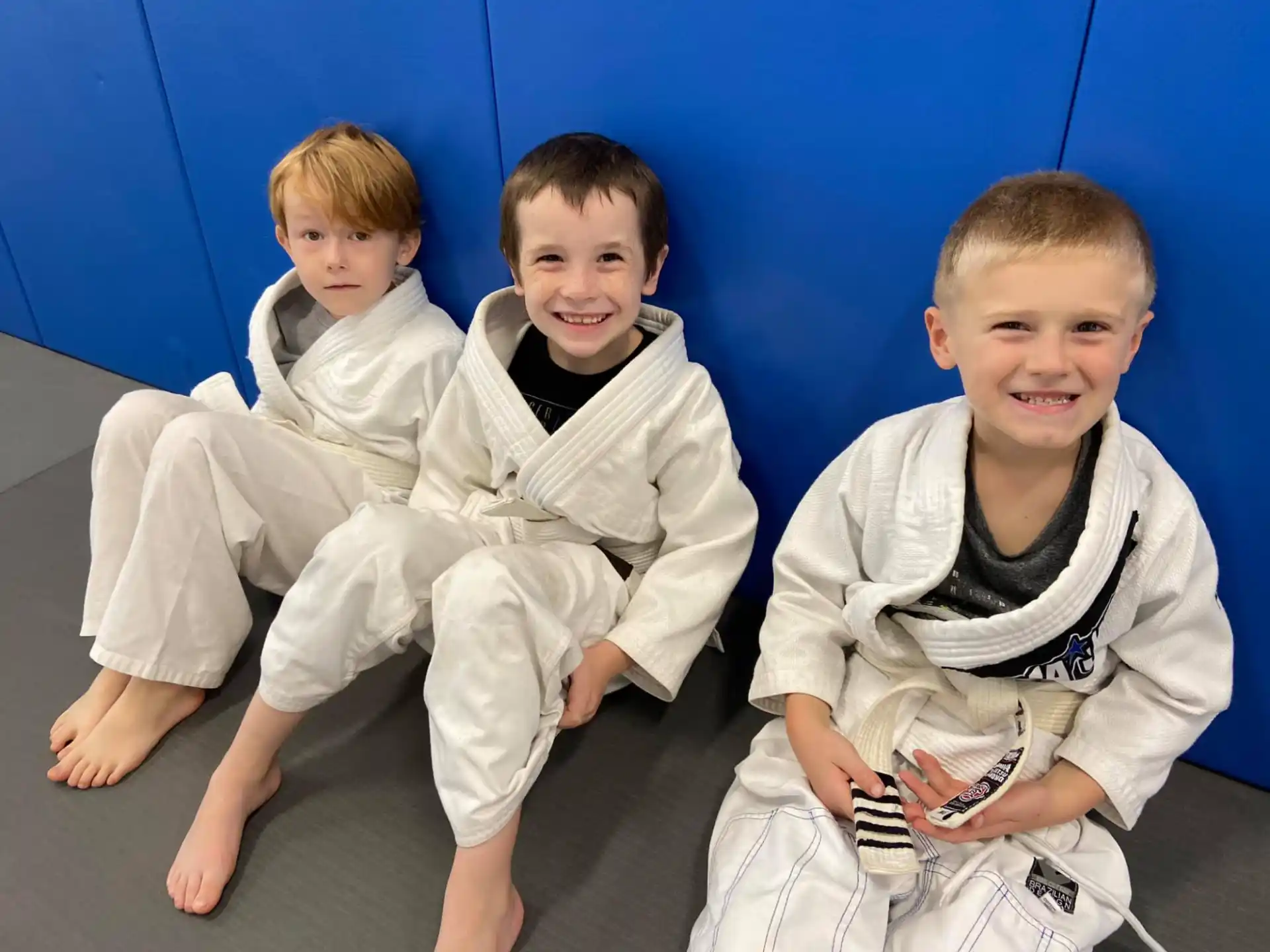 a group of boys in karate uniforms