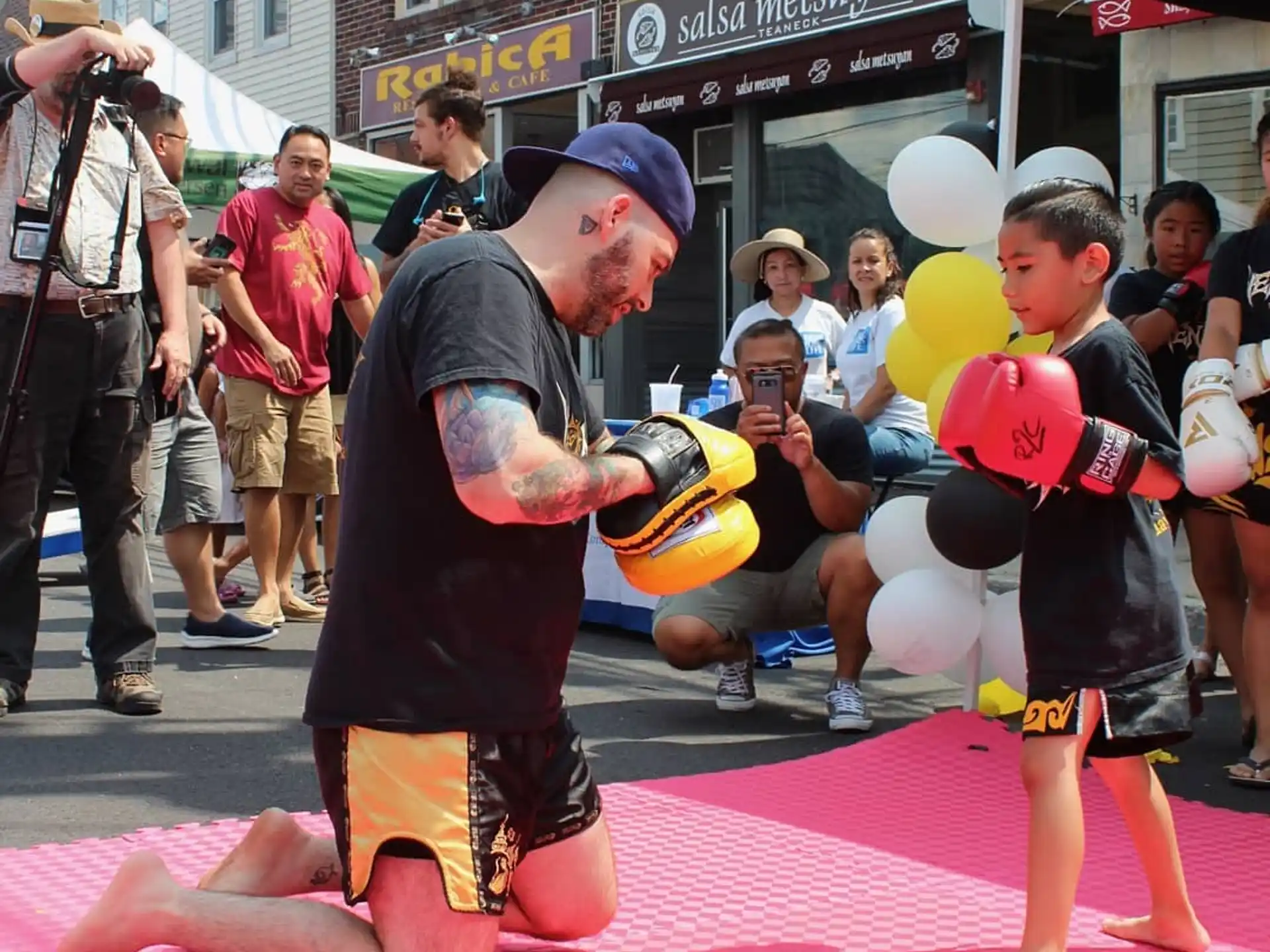 a person kneeling down next to a child in a garment