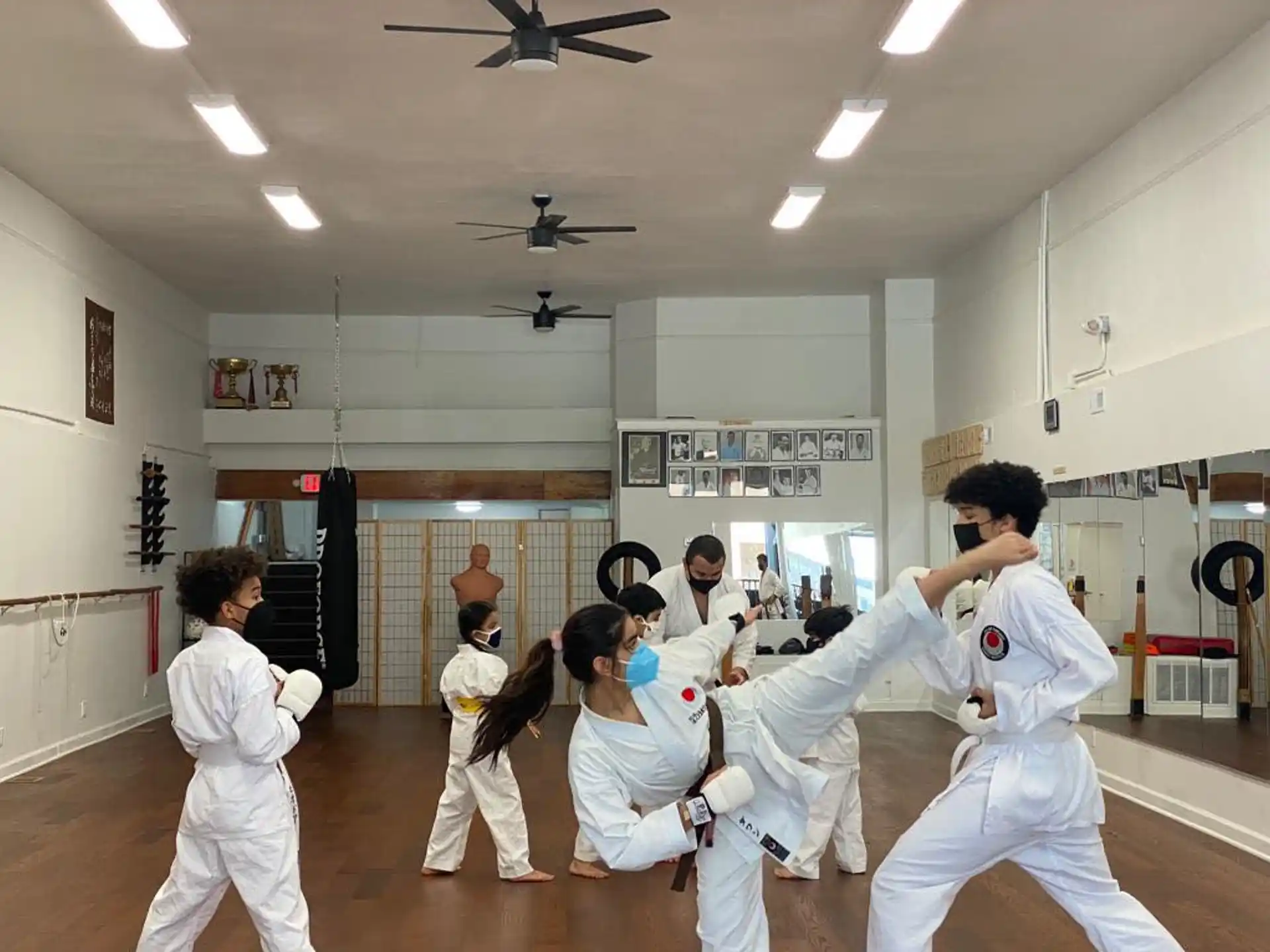 a group of people in white karate uniforms in a room