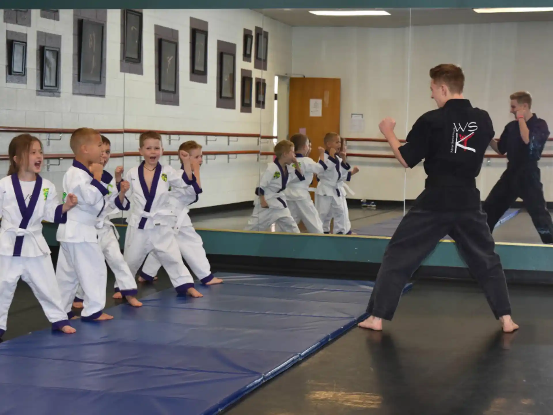 a group of children in karate uniforms