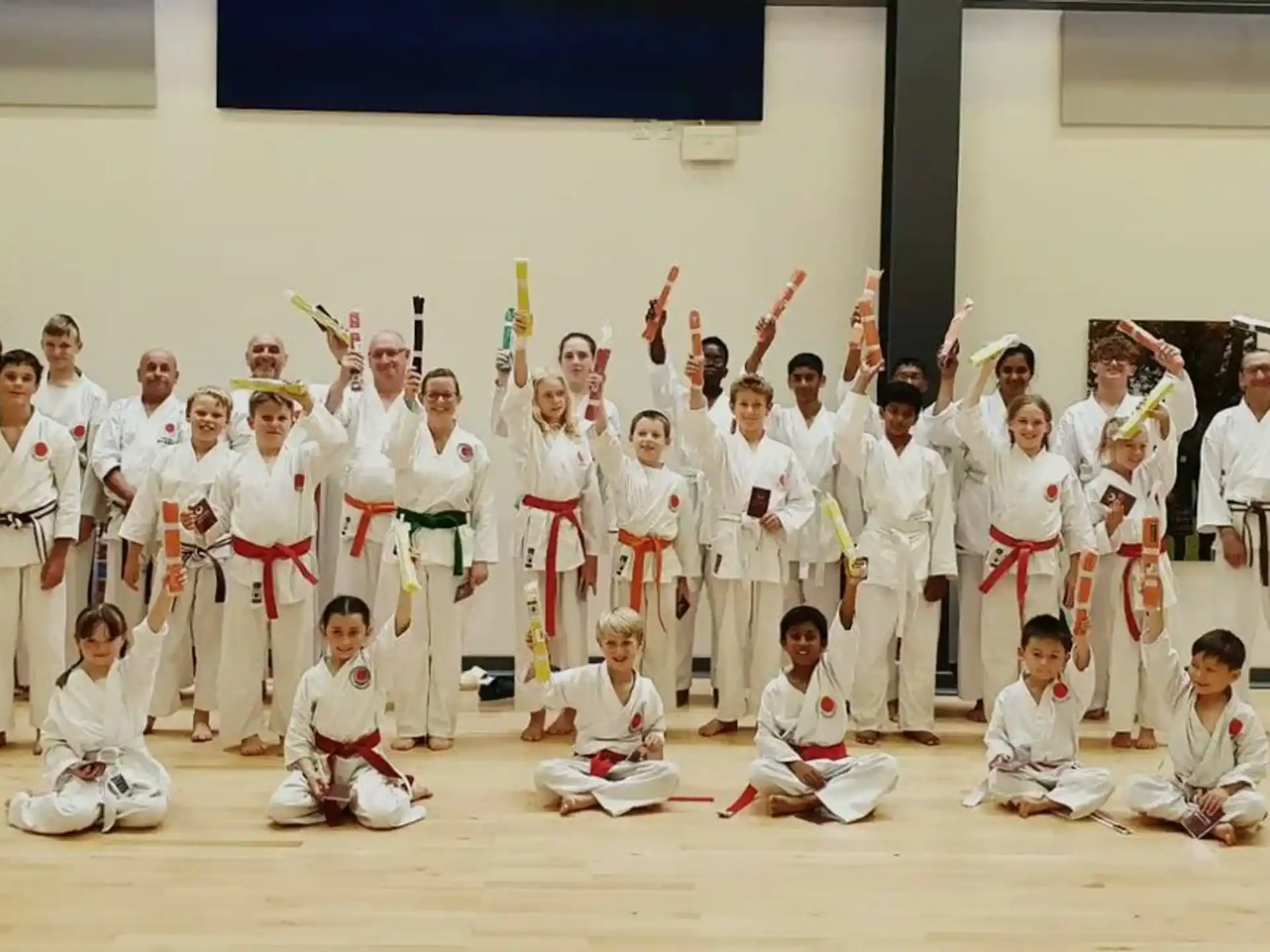 a group of people in white karate uniforms