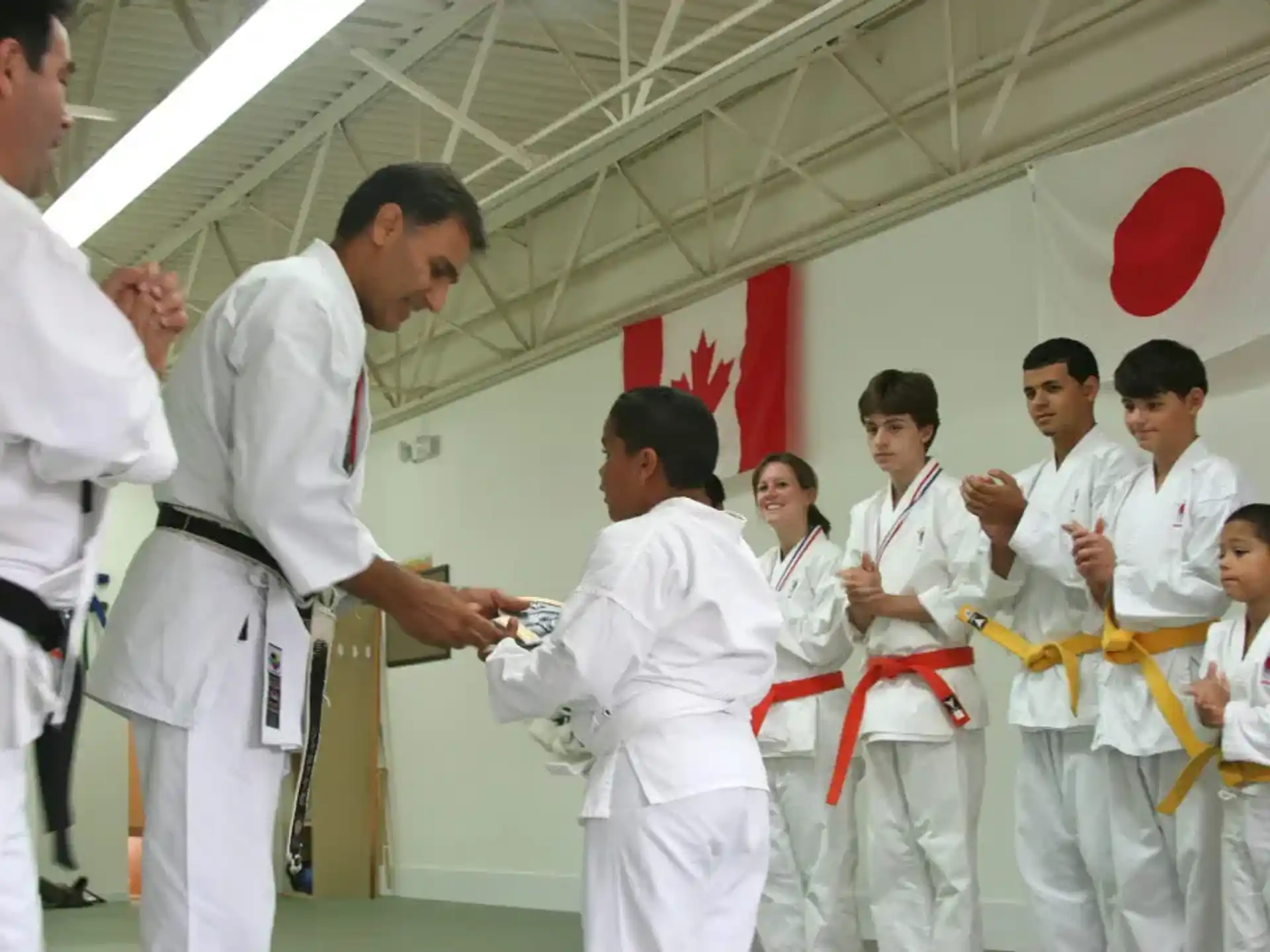 a group of people in white karate uniforms