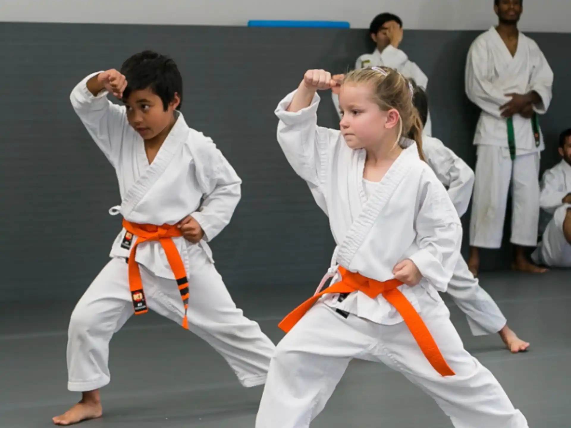 a man and a woman in karate uniforms