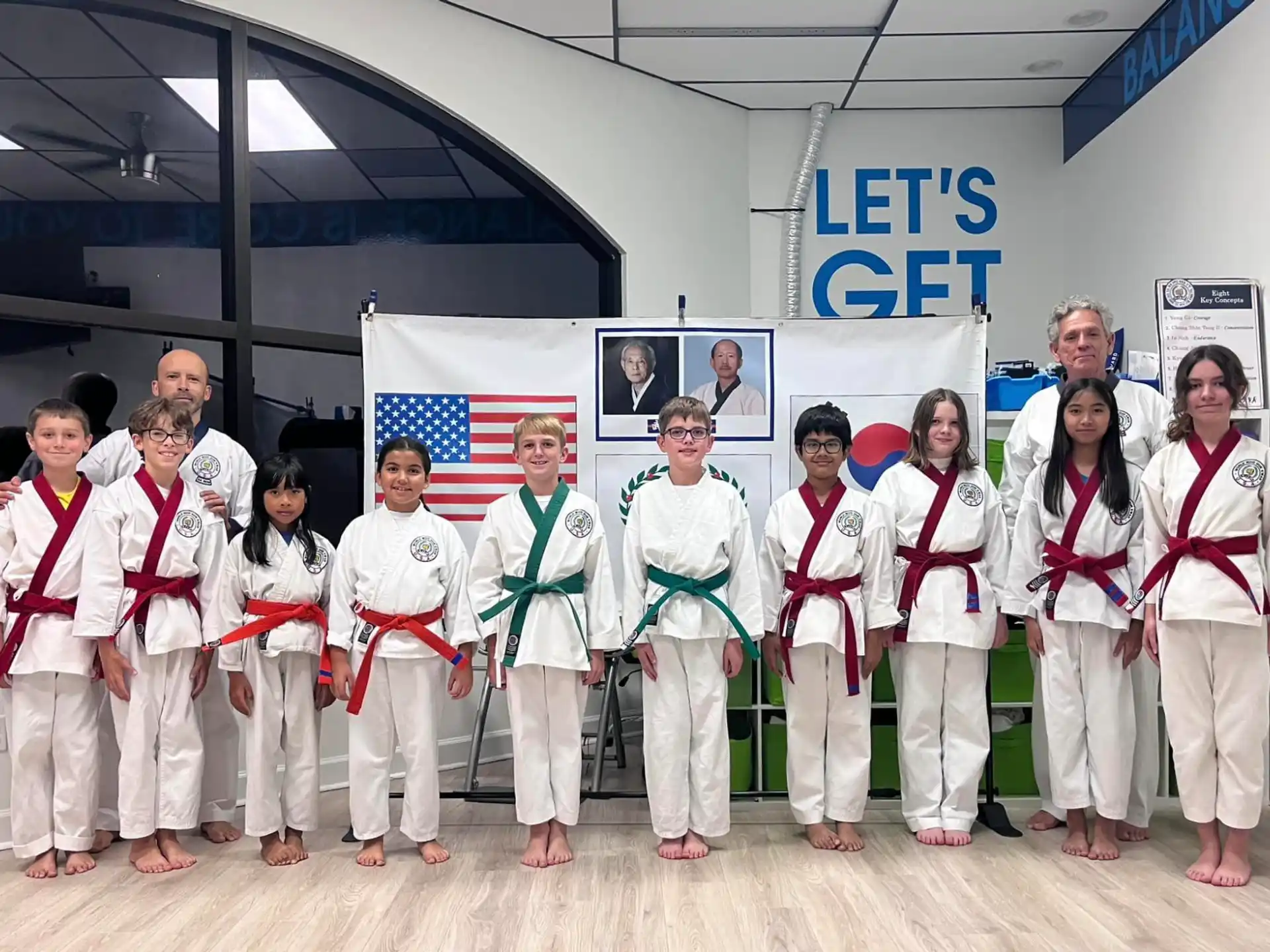 a group of people in white karate uniforms