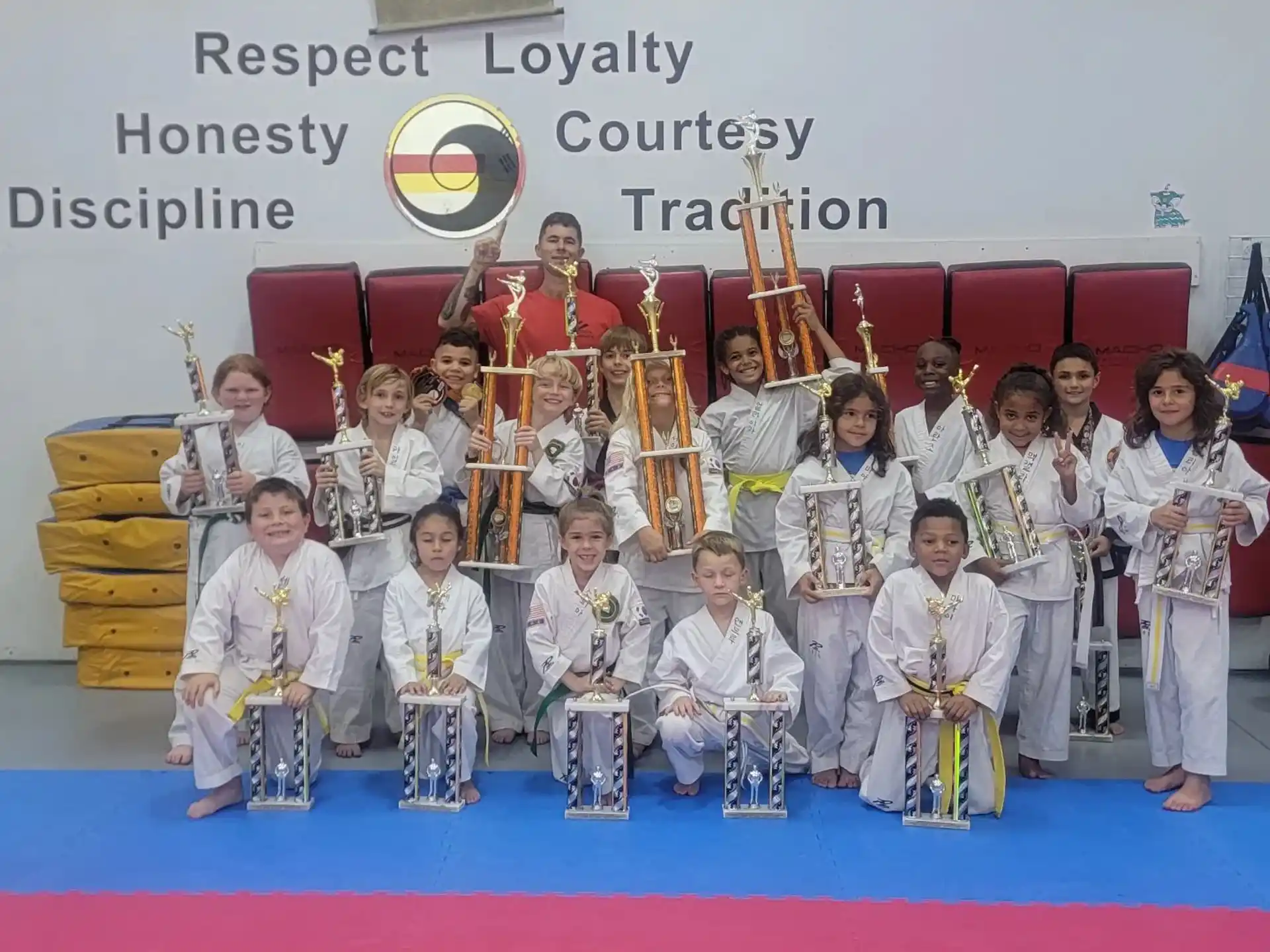 a group of kids in karate uniforms