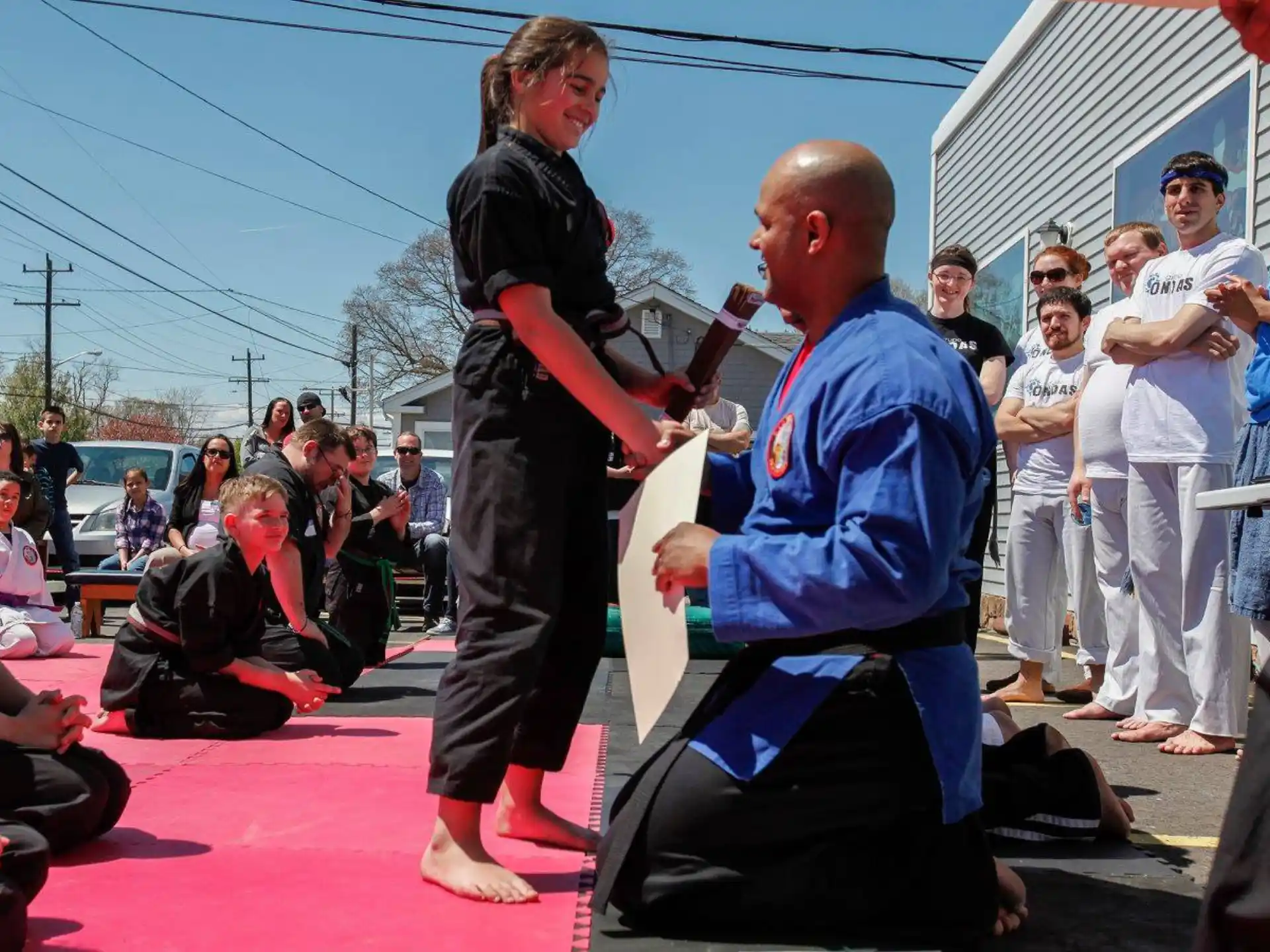 a person holding a person's hand while walking on a red carpet