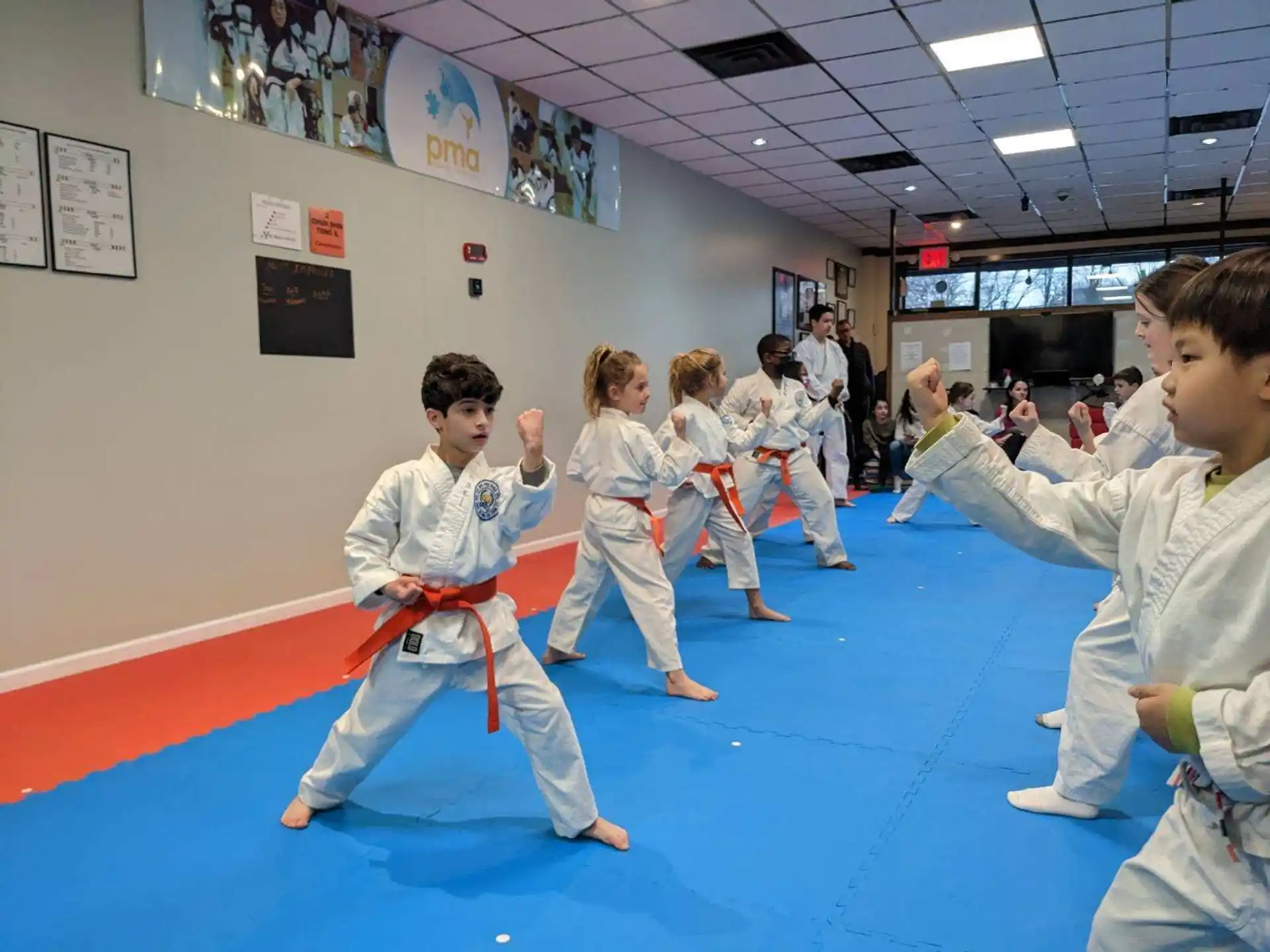 a group of children in karate uniforms