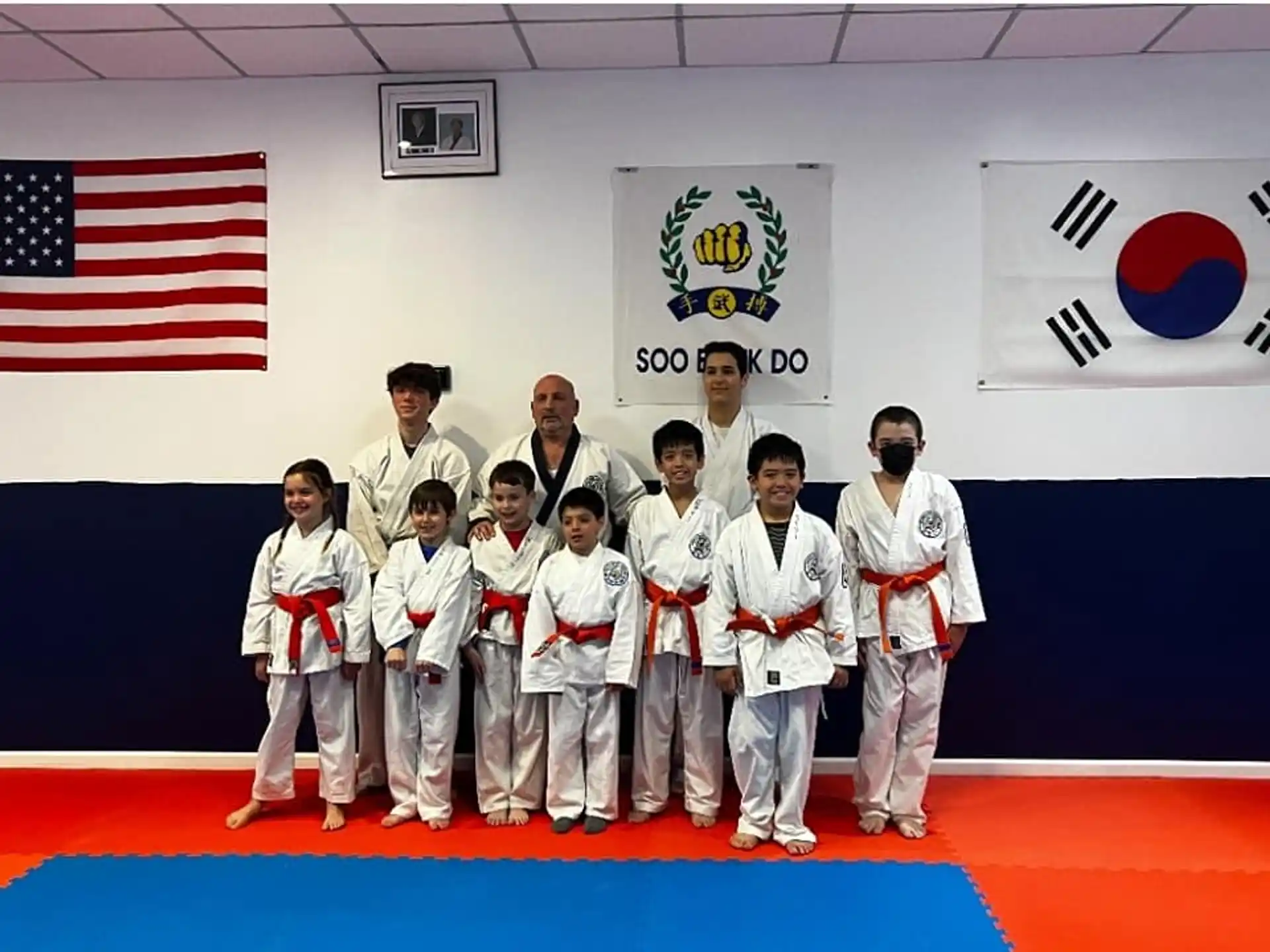 a group of people in karate uniforms