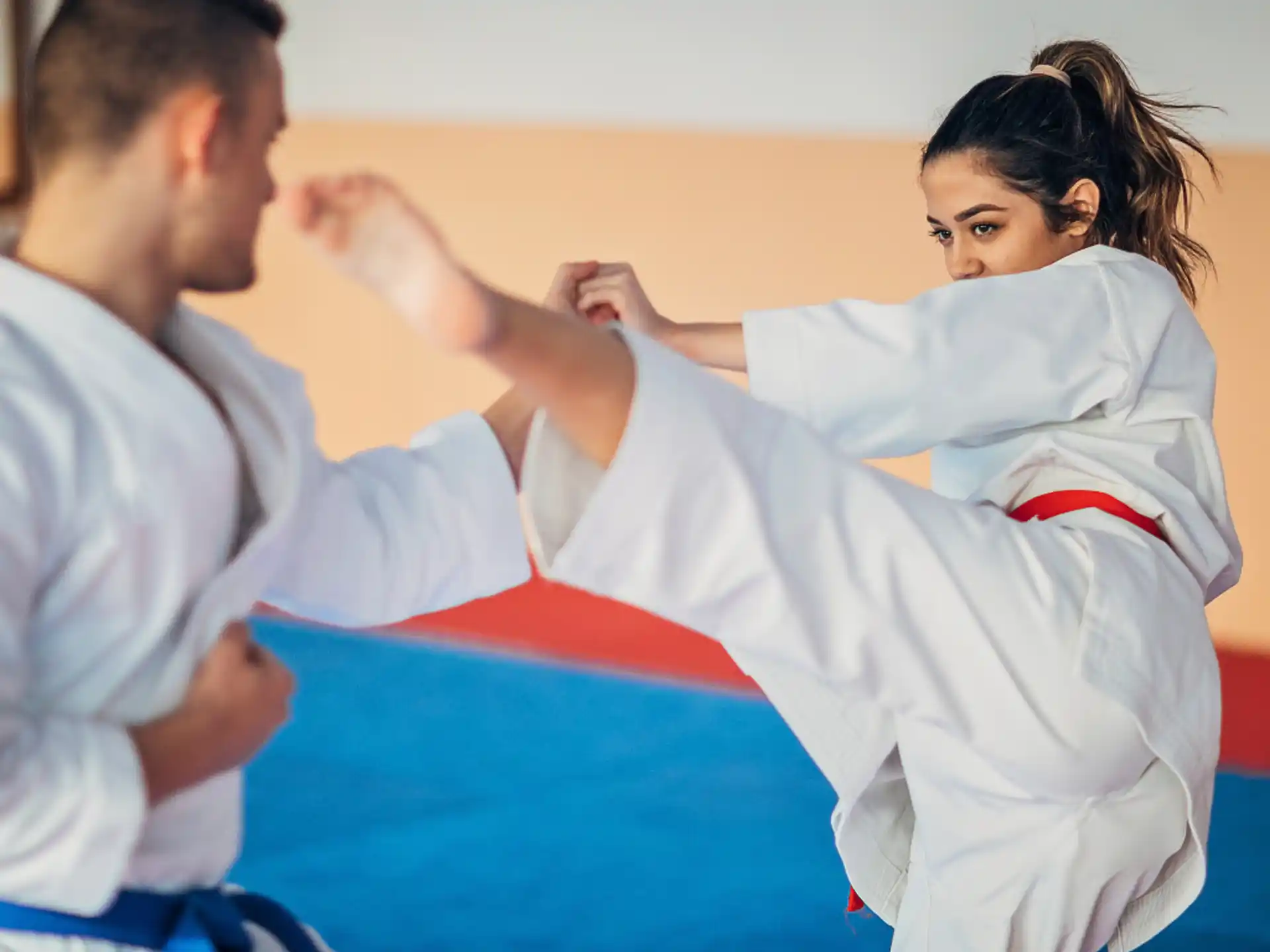 a man and a woman in karate uniforms