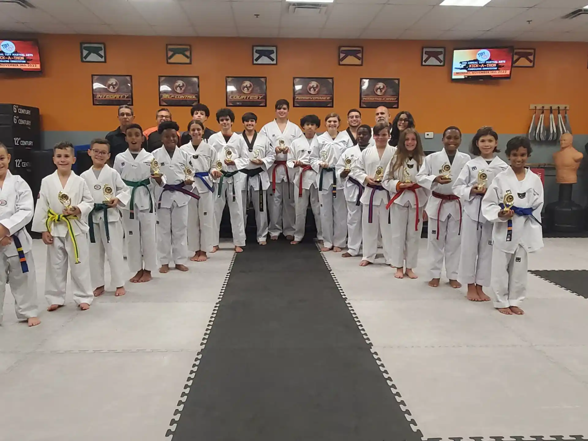 a group of people in white karate uniforms