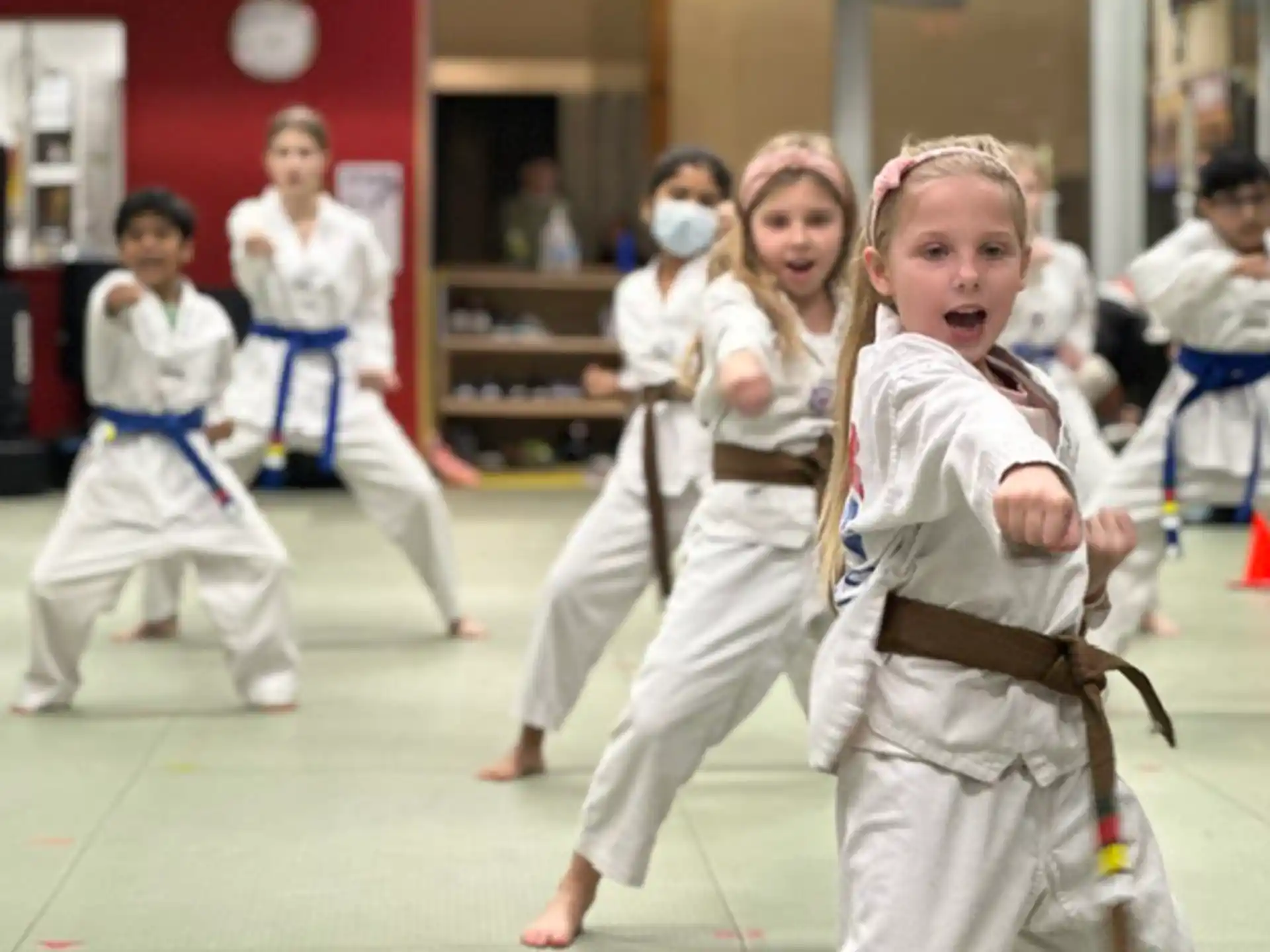 a group of children in karate uniforms