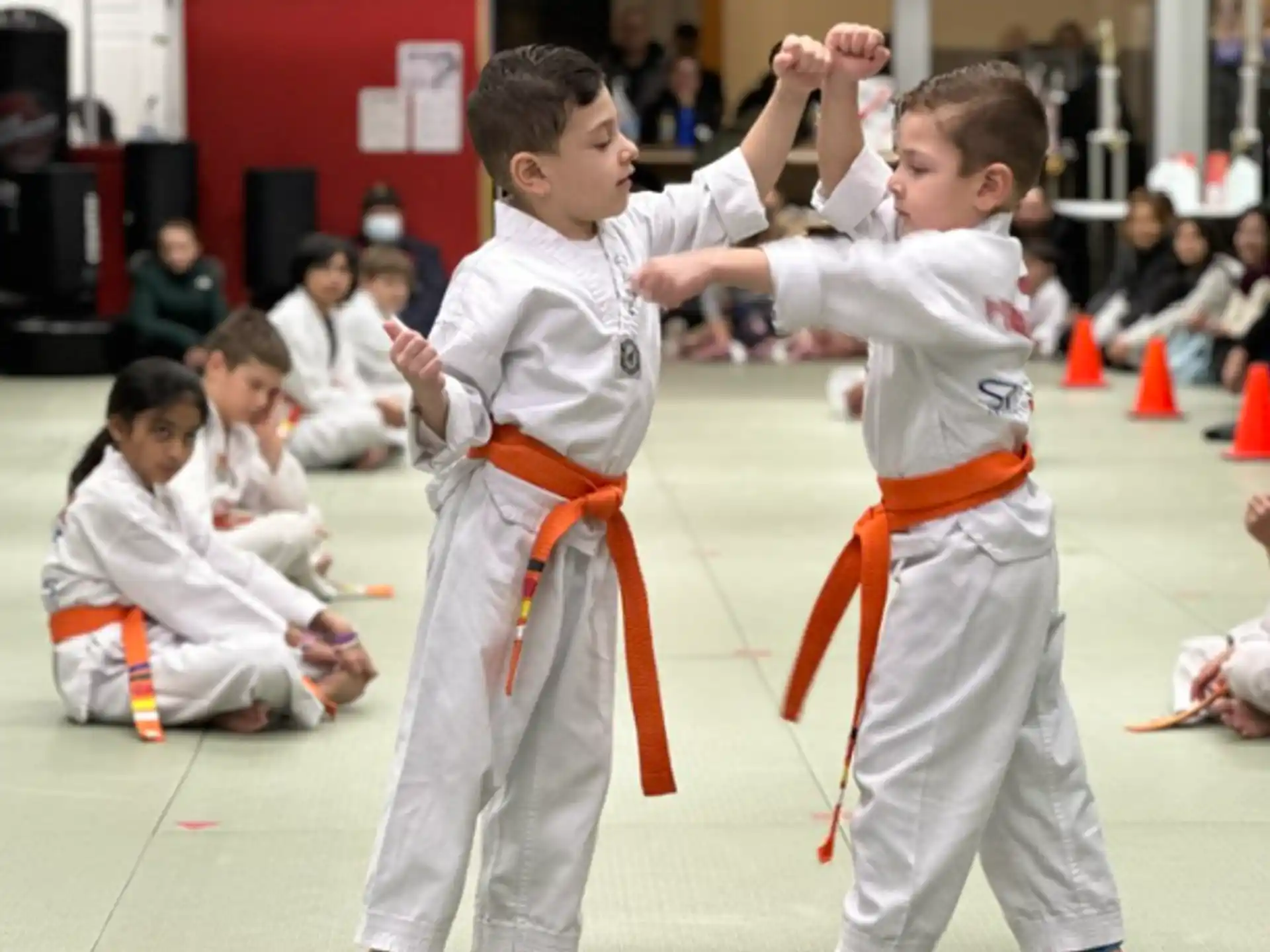 a group of children in karate uniforms