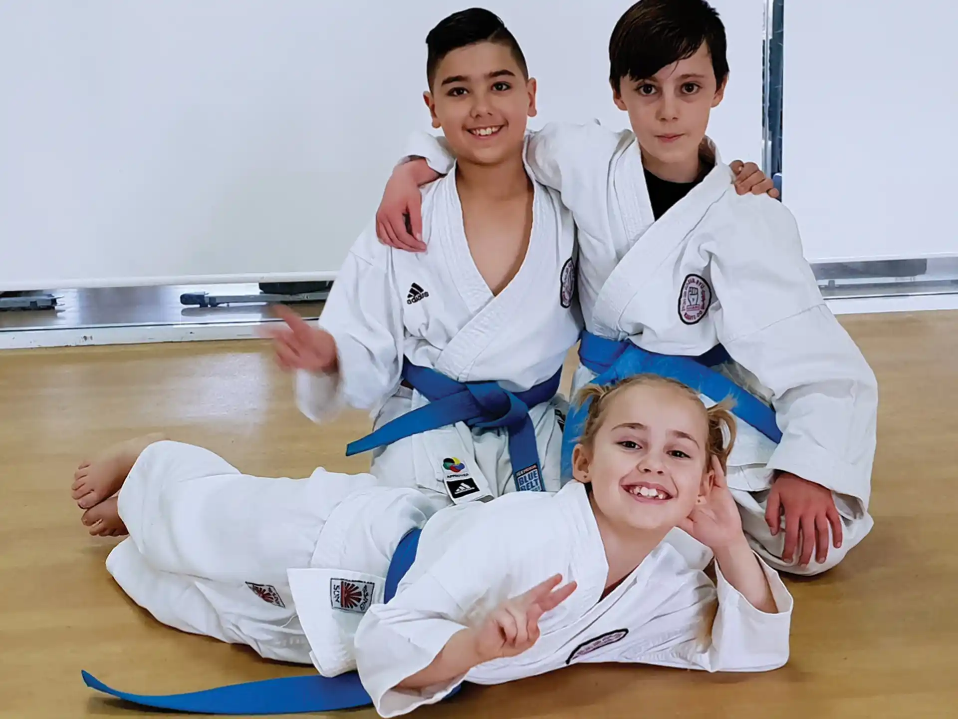 a group of people in karate uniforms
