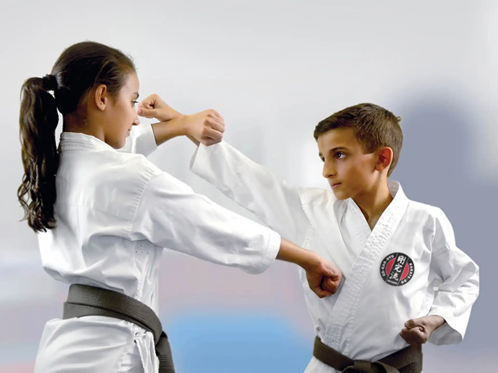 a woman and a man in karate uniforms