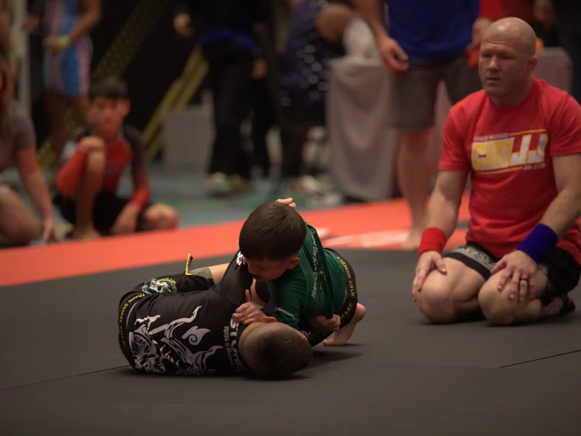 a person kneeling down next to a person who is lying down