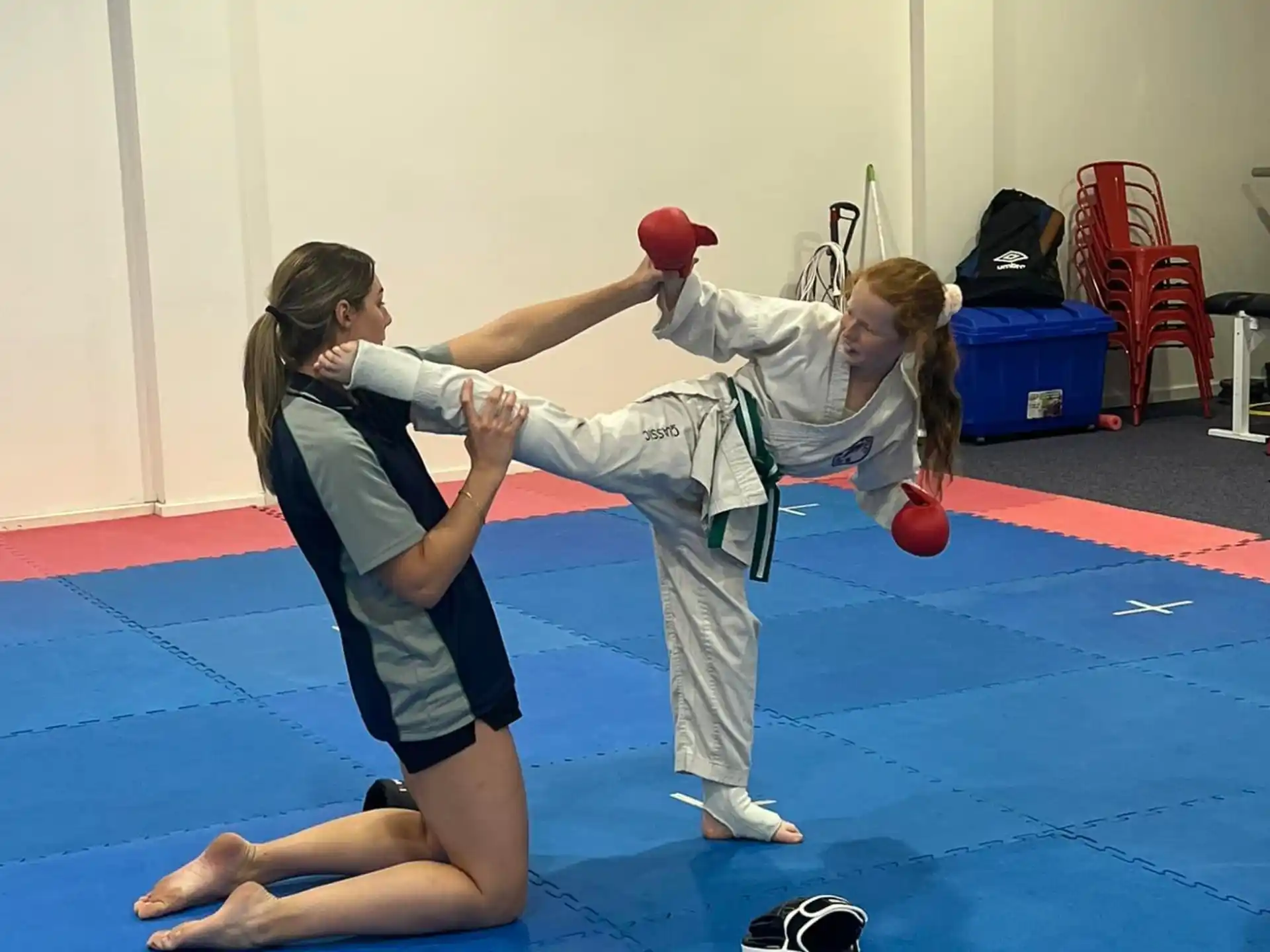 a man and a woman practicing martial arts