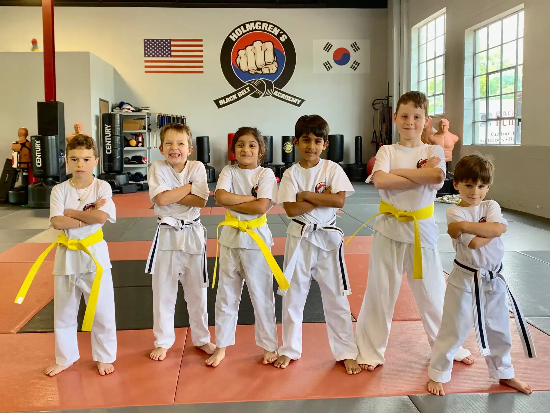 a group of children in karate uniforms