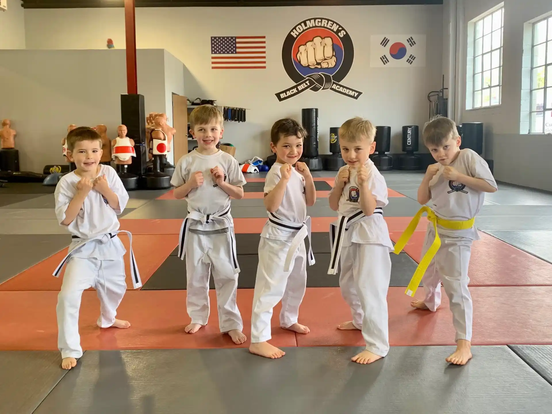 a group of kids in karate uniforms