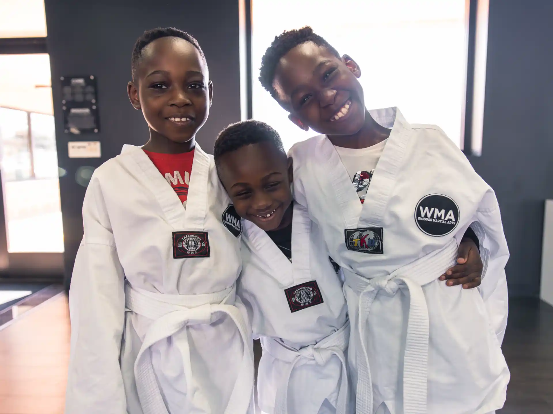 a group of people wearing white lab coats and smiling