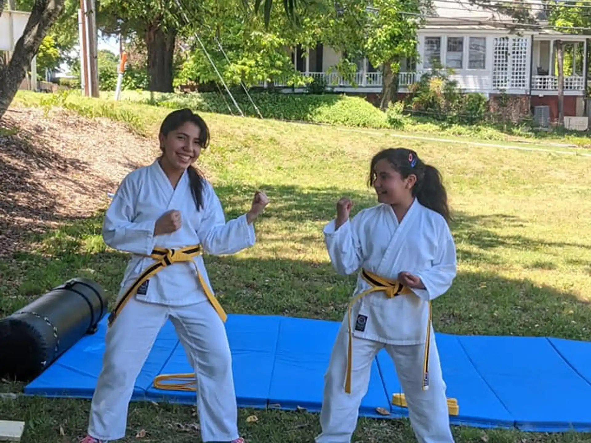 a couple of people in karate uniforms