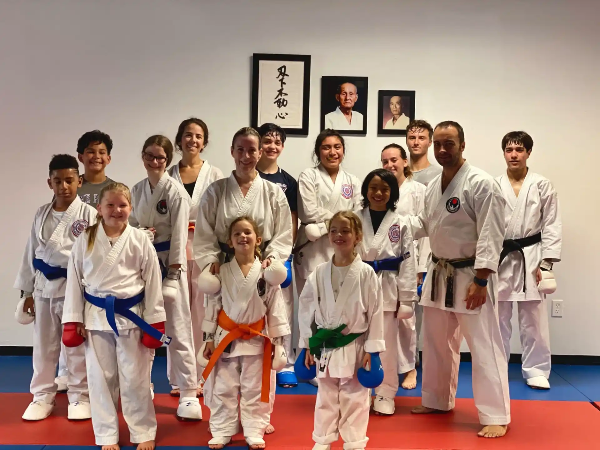 a group of people in white karate uniforms