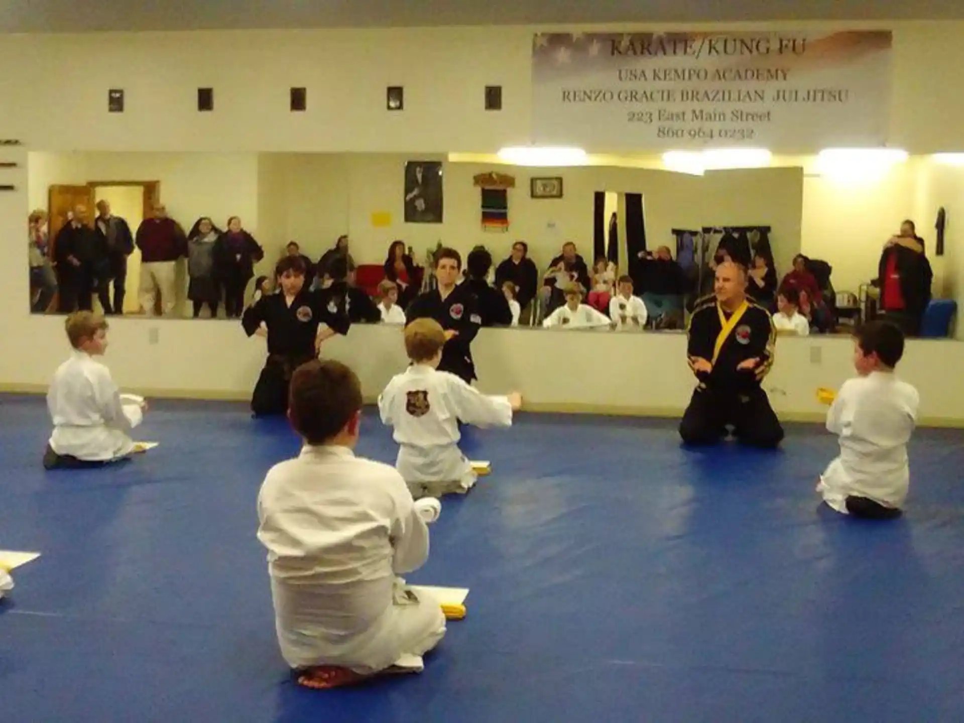 a group of children sitting on the floor in a room