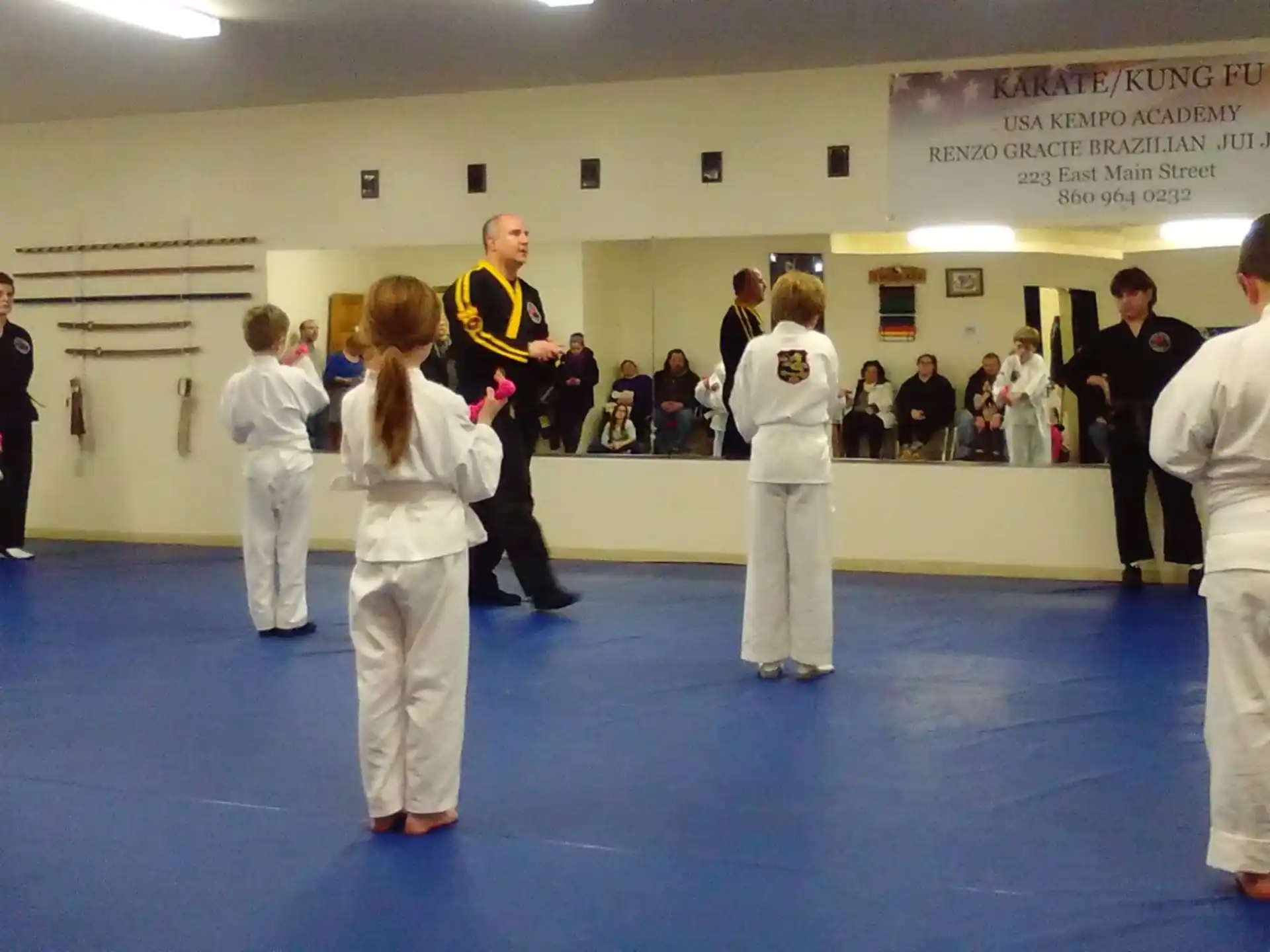 a group of people in white karate uniforms