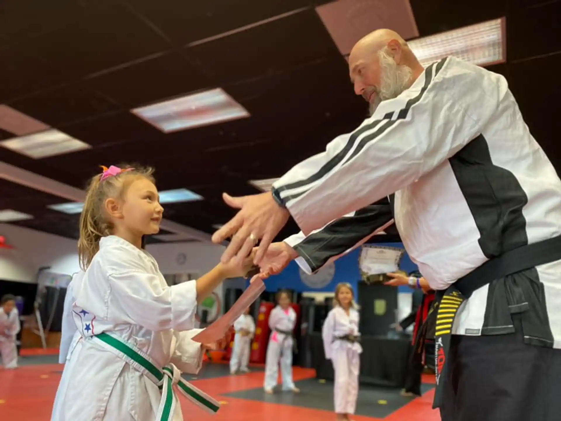 a person and a girl in karate uniforms
