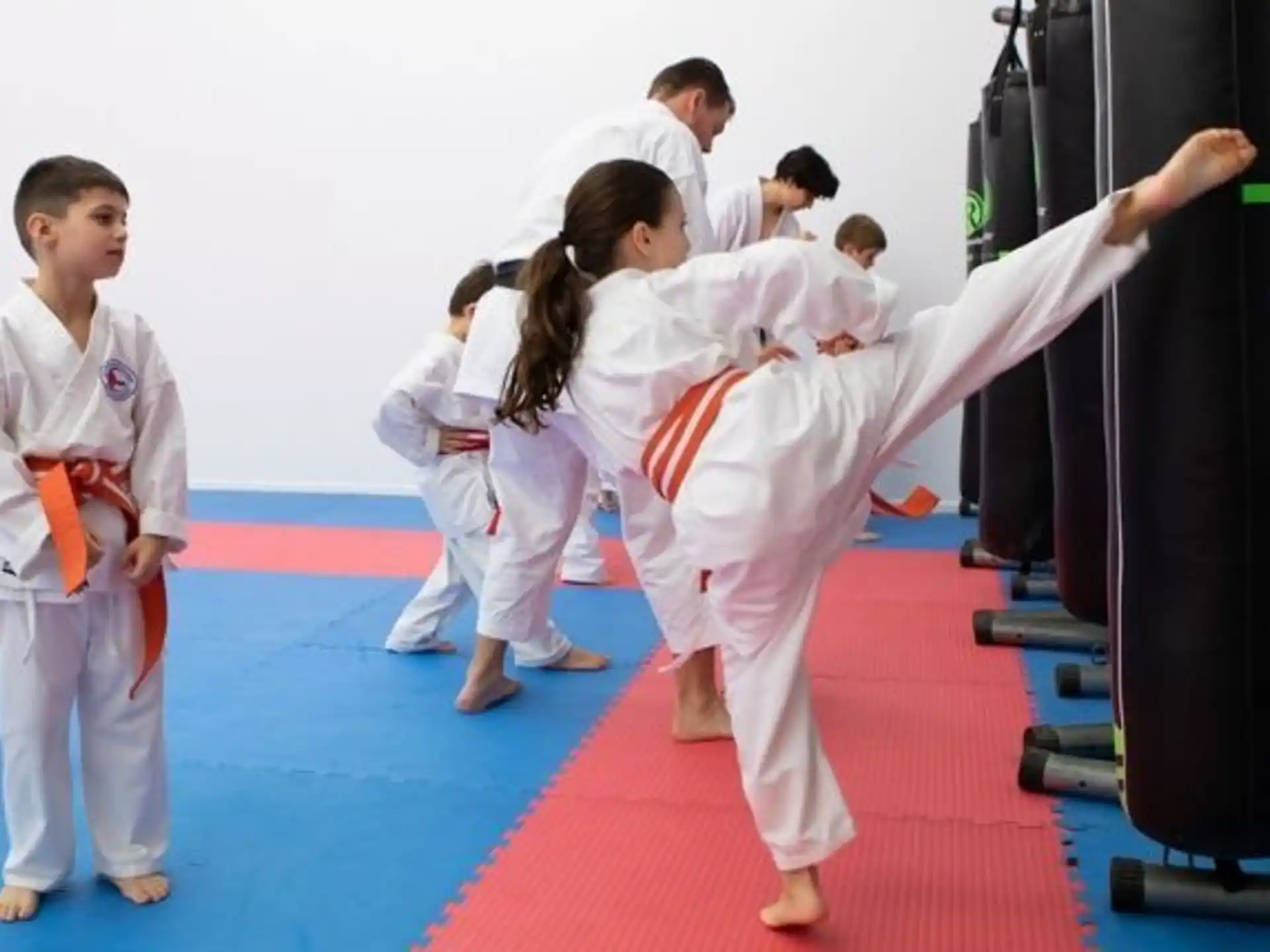 a group of children practicing karate