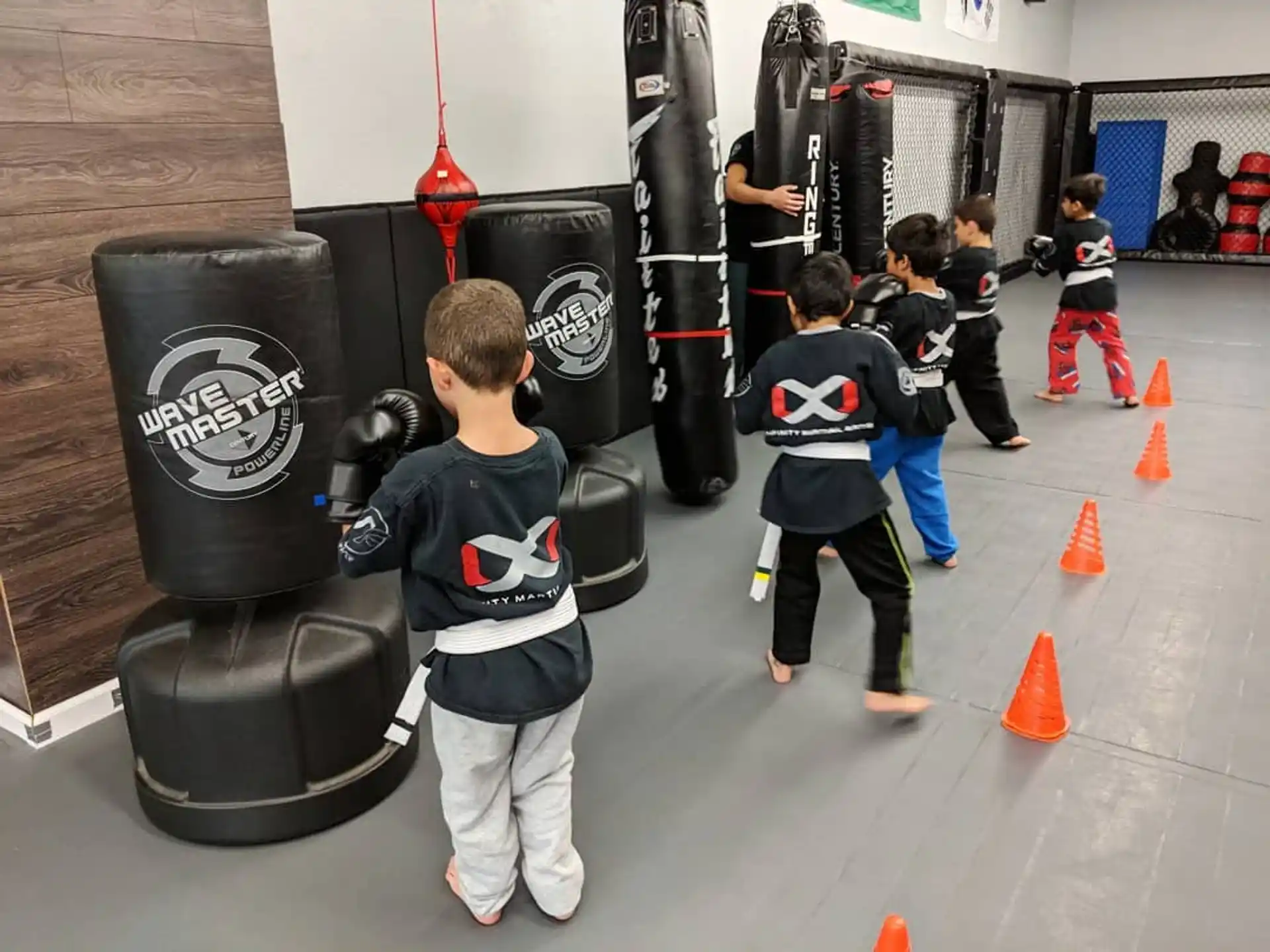 a group of kids playing with a black speaker