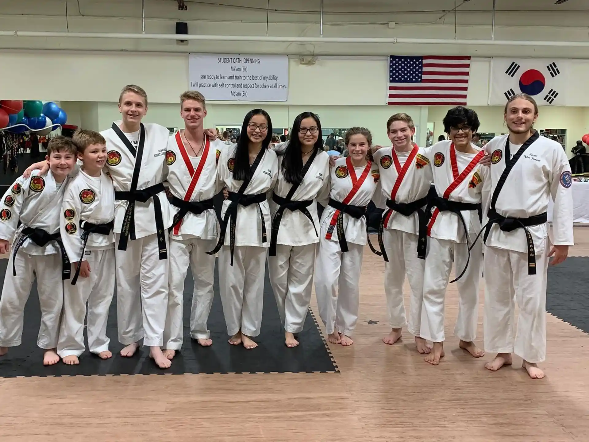a group of people in white karate uniforms