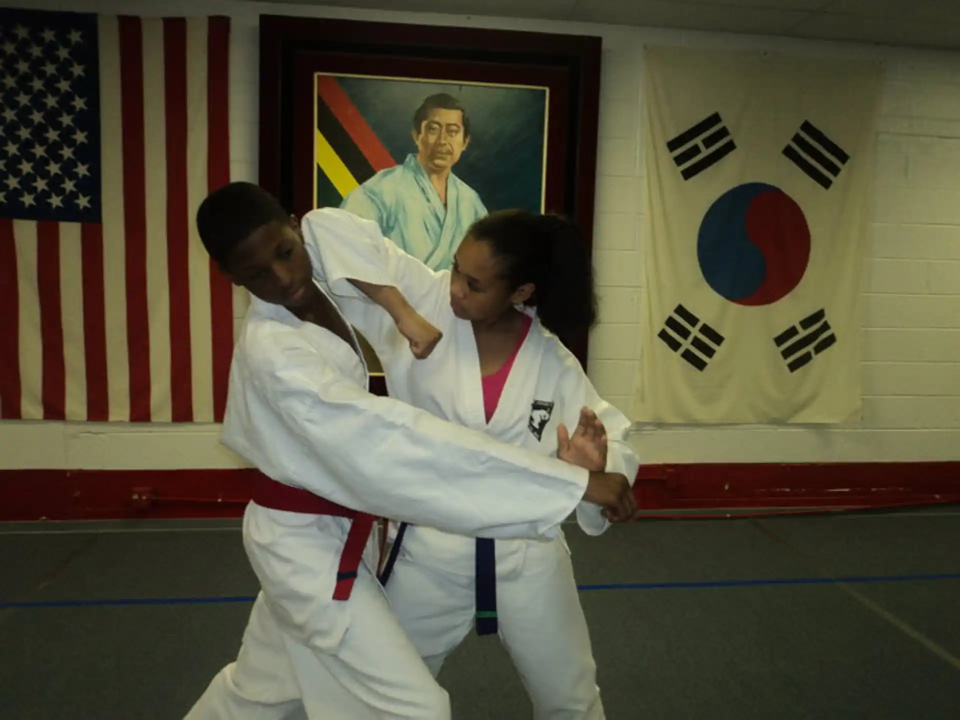 a man and woman in karate uniforms