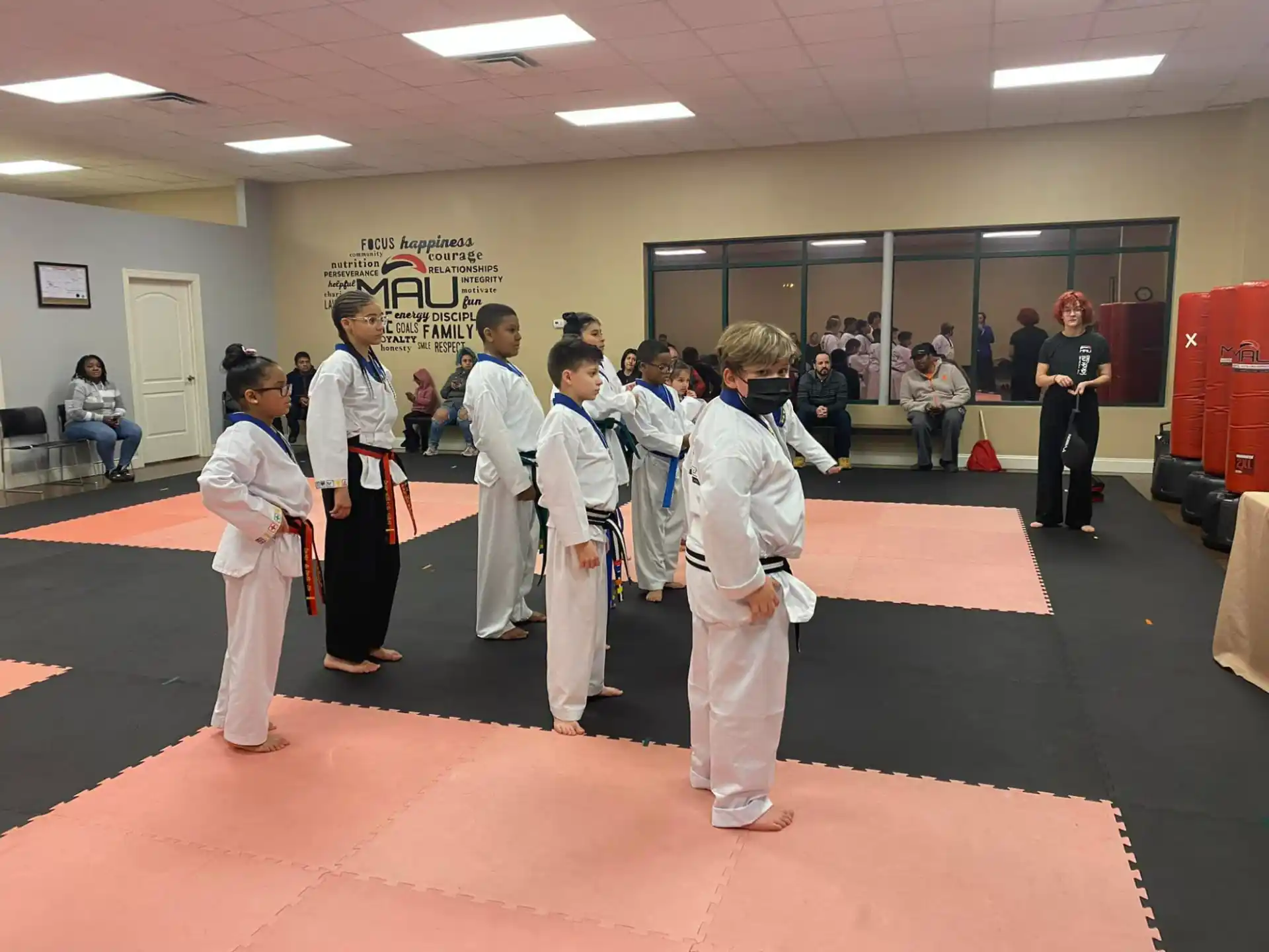 a group of people in white karate uniforms
