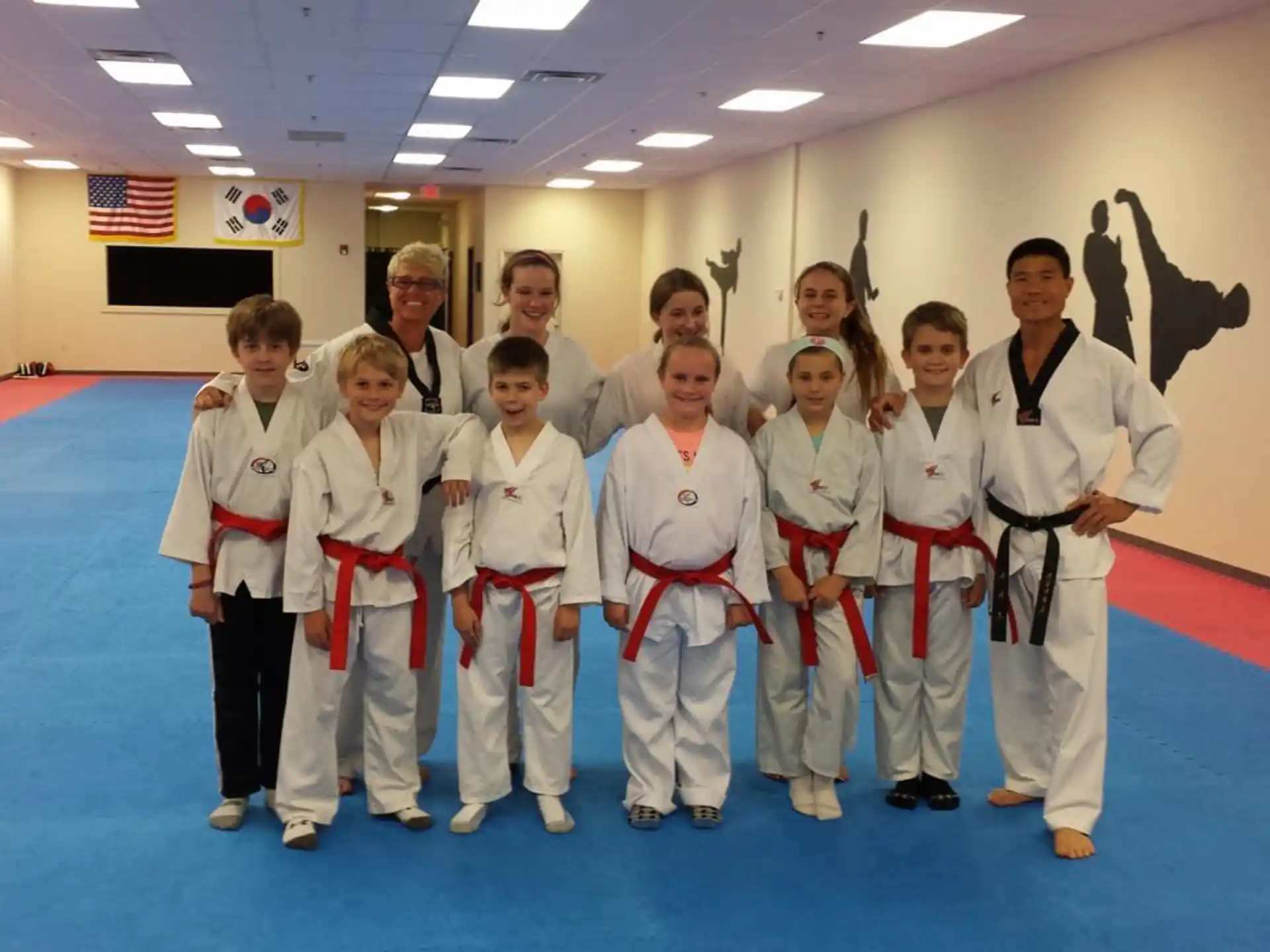 a group of people in white karate uniforms