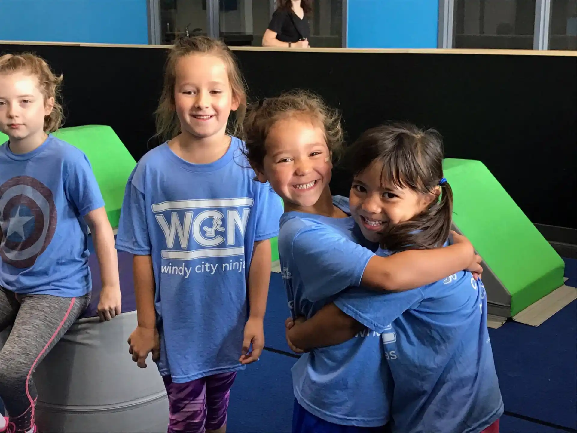 a group of children in blue shirts