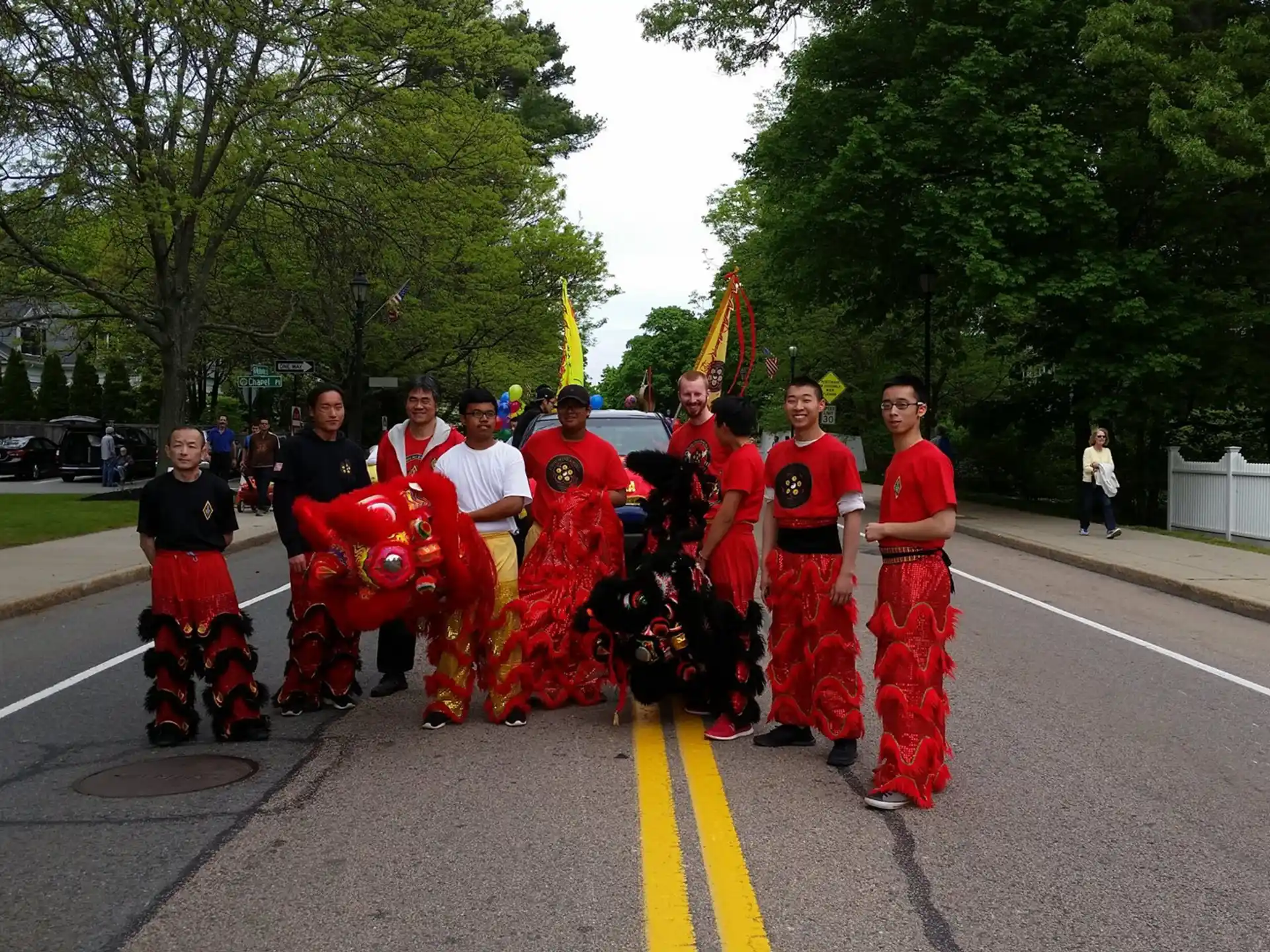 a group of people in red and white outfits walking down a street