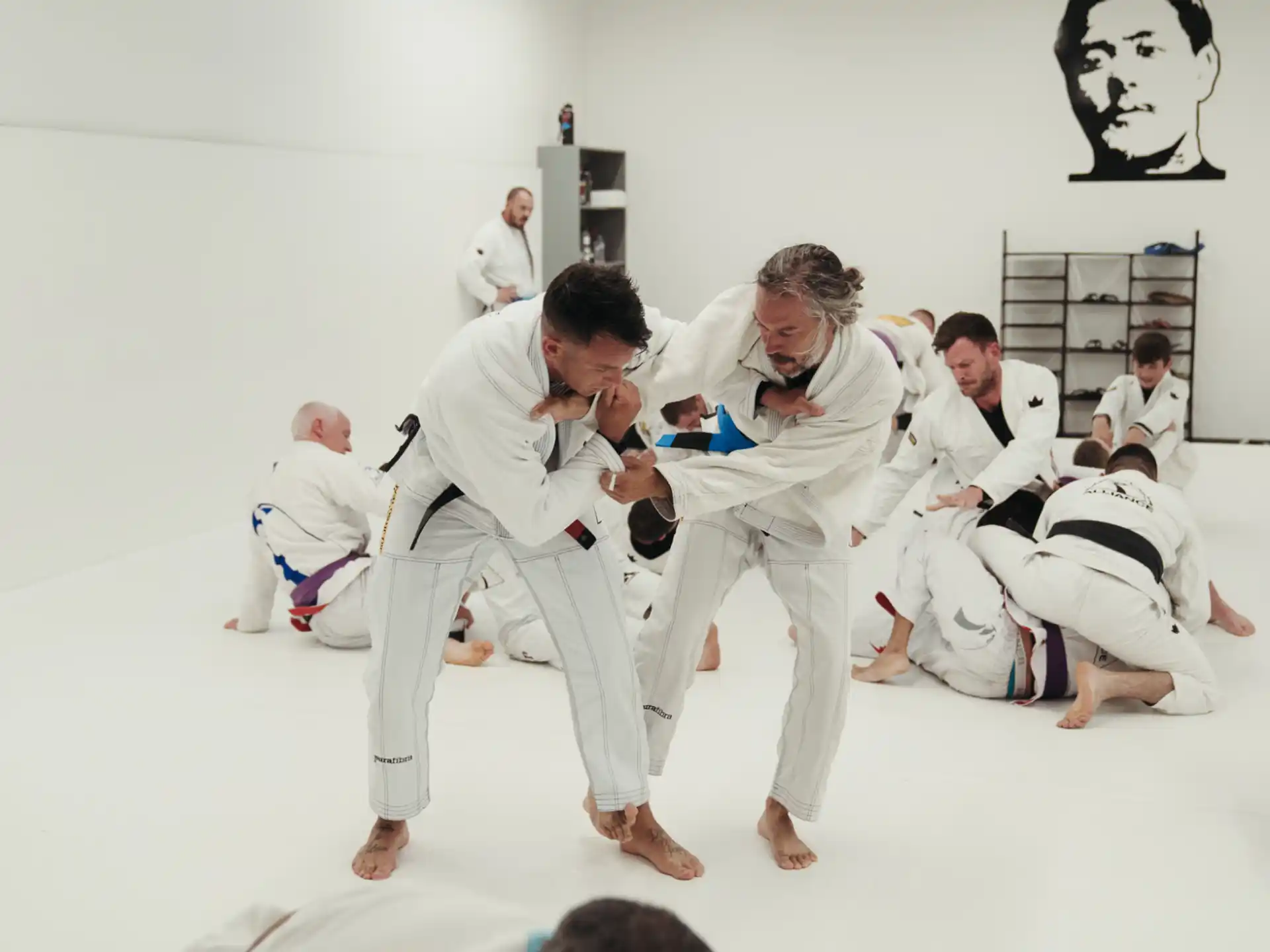 a group of people in white karate uniforms
