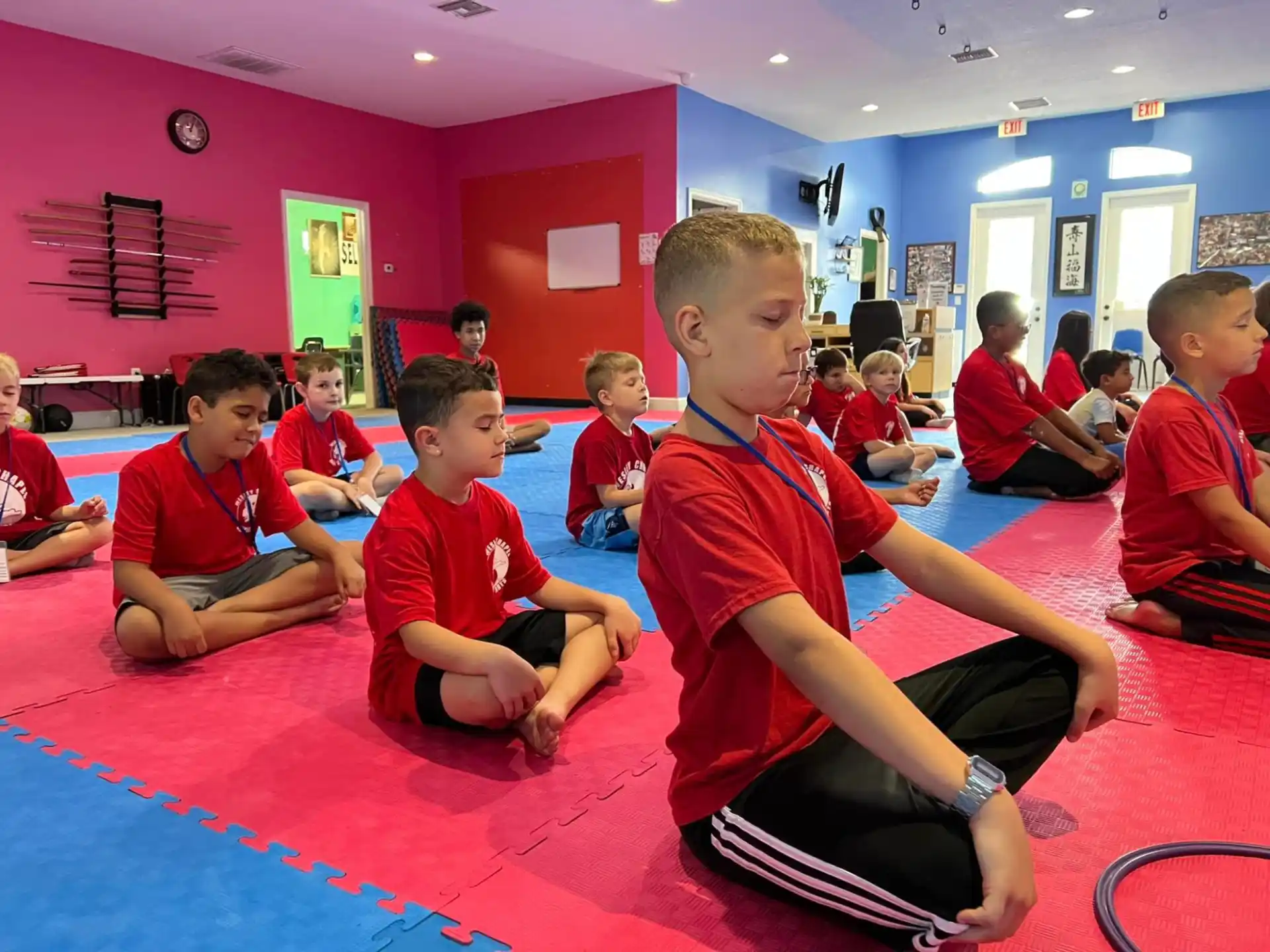 a group of children sitting on the floor in a room