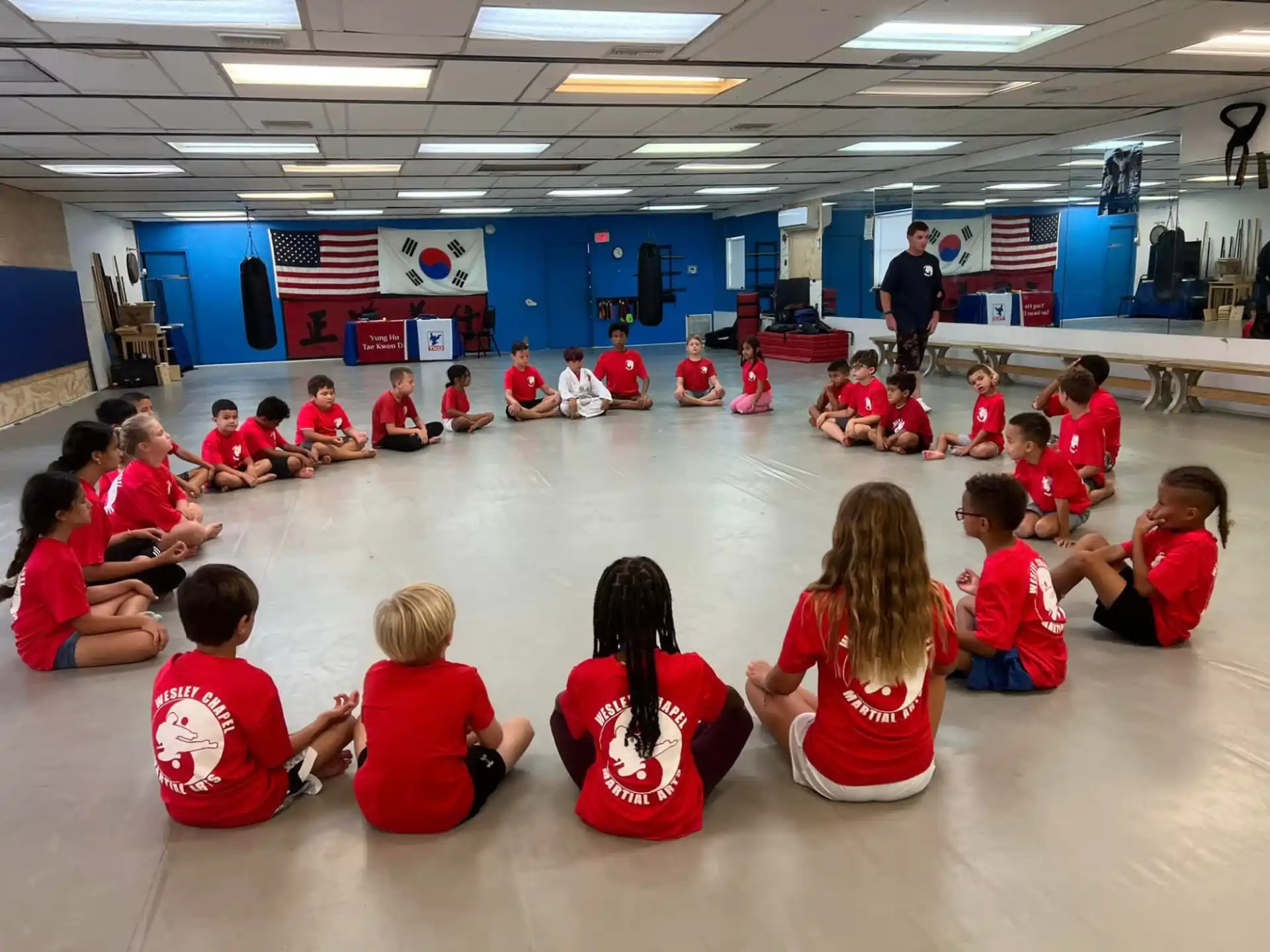 a group of children sitting on the floor in a room