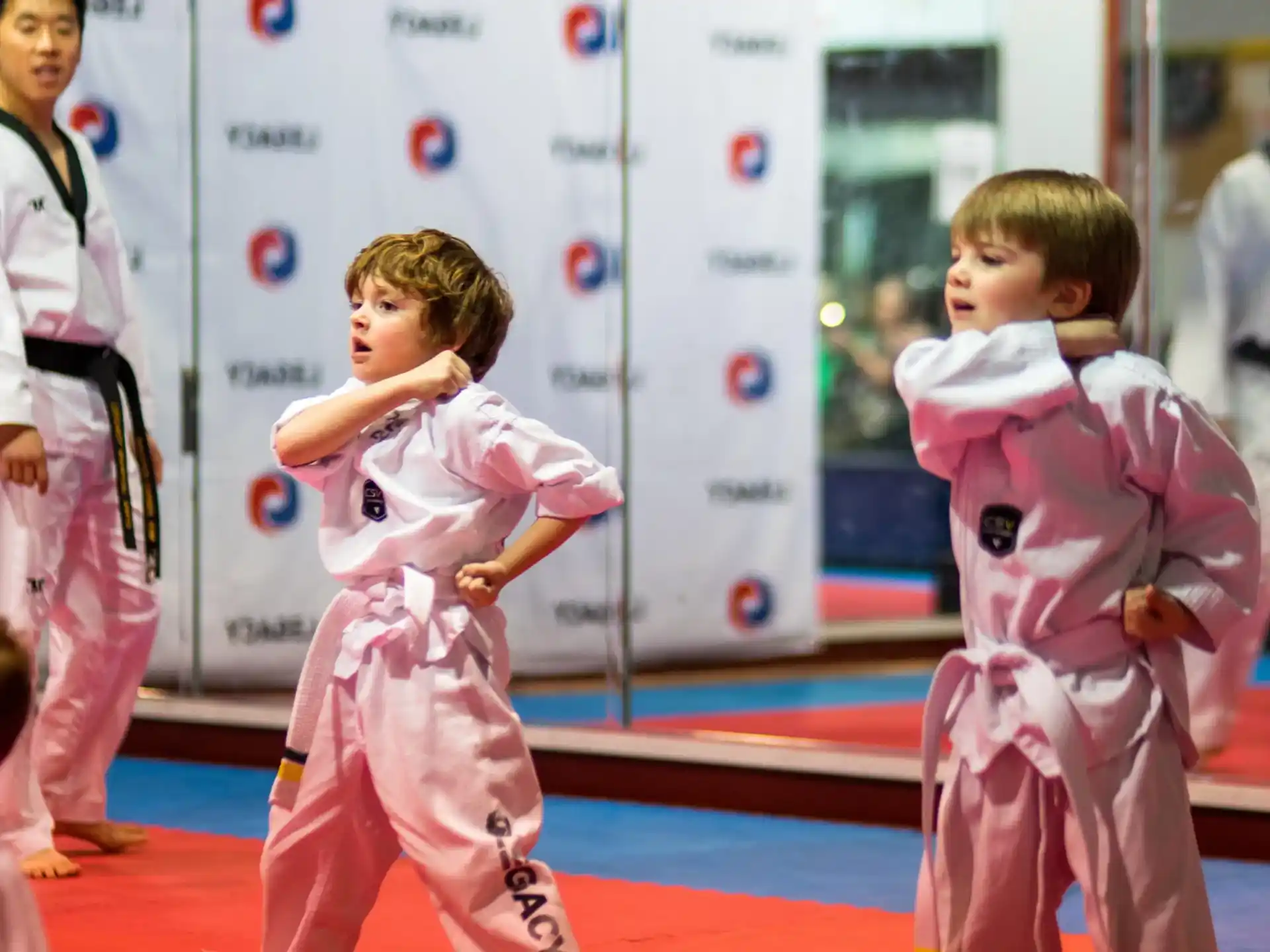 a group of children in karate uniforms