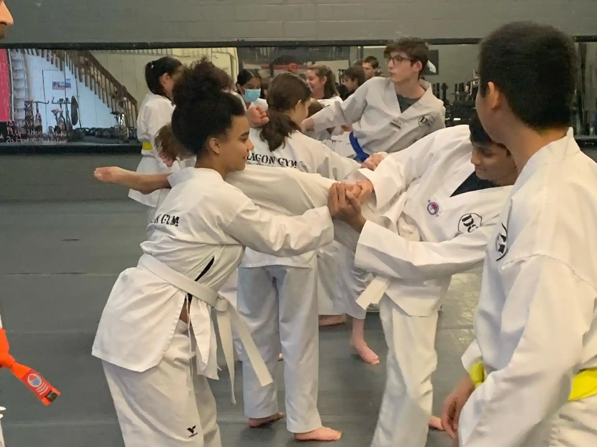 a group of people in white karate uniforms