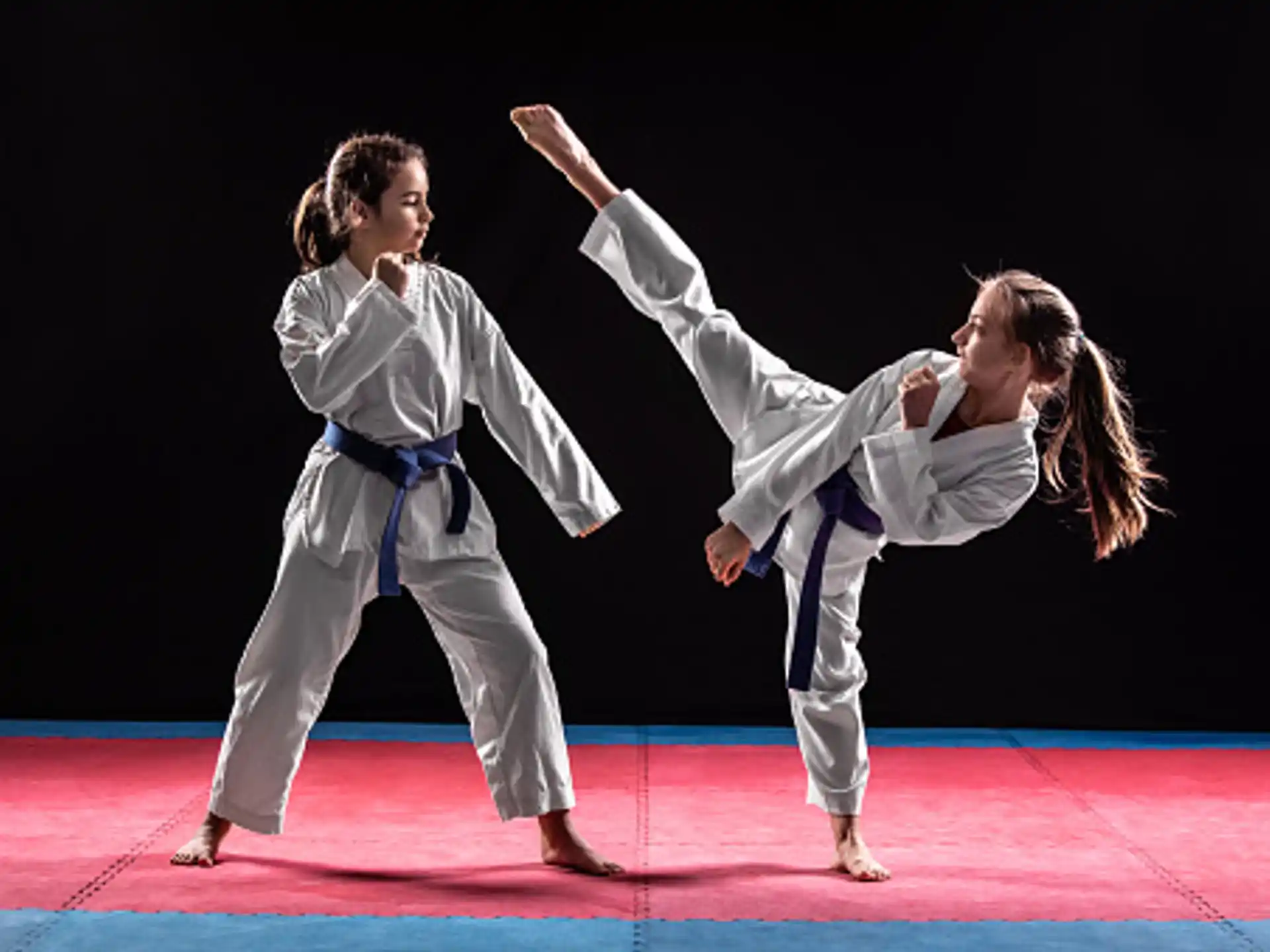 a man and a woman in karate uniforms on a stage